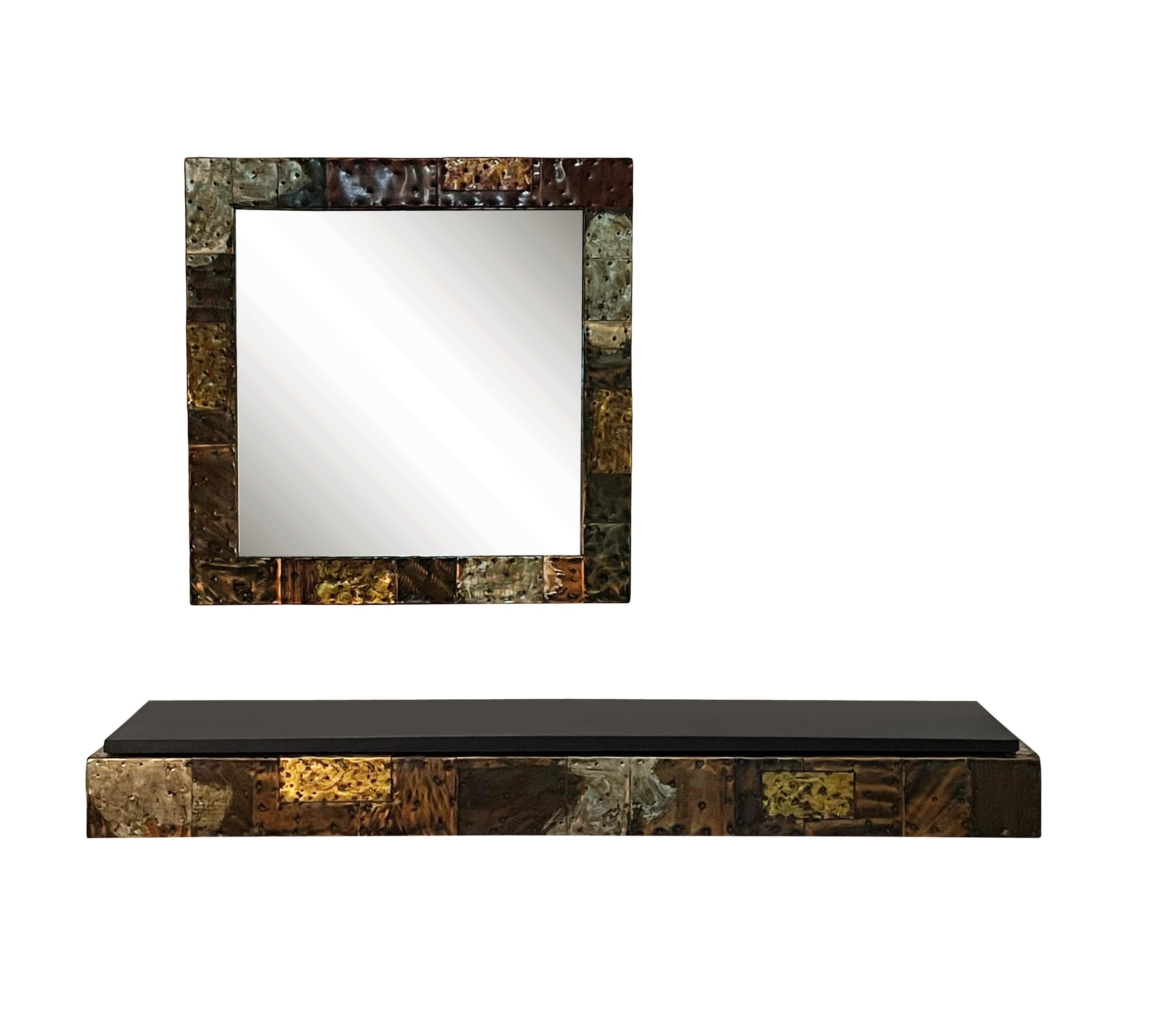 Paul Evans studio floating shelf and mirror set circa early 1970's. It features copper, bronze and pewter cladding in a patchwork design. Console shelf measures 60 x 13 x 6.5 inches with heavy black slate top. Mirror measures 30 inches. All in very