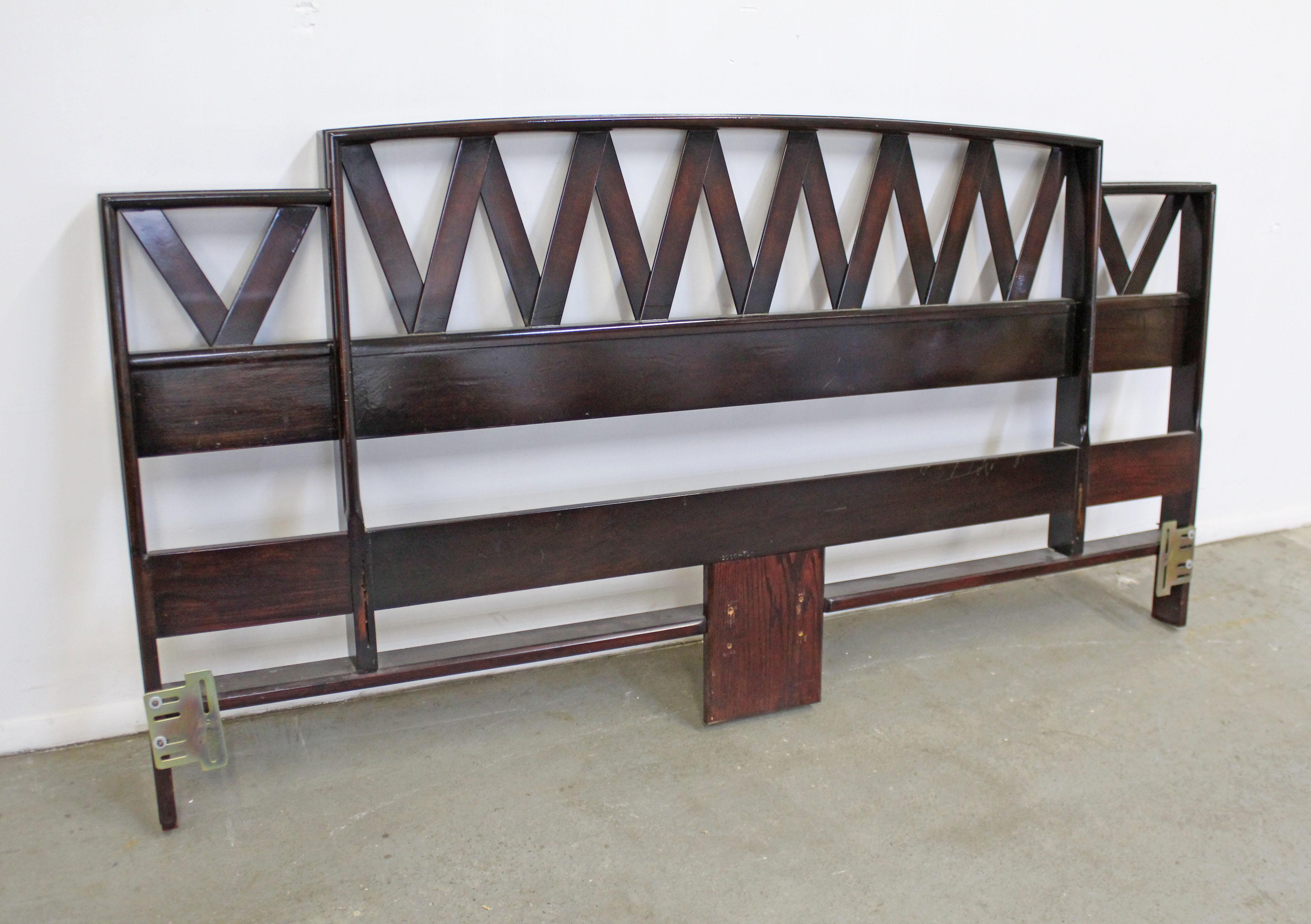 Offered is a vintage king size headboard with a zig-zag pattern designed by Paul Frankl. Looks to be walnut in a dark finish and shiny stain. It is in good structurally sound vintage with some surface scratches (see photos). Metal brackets were