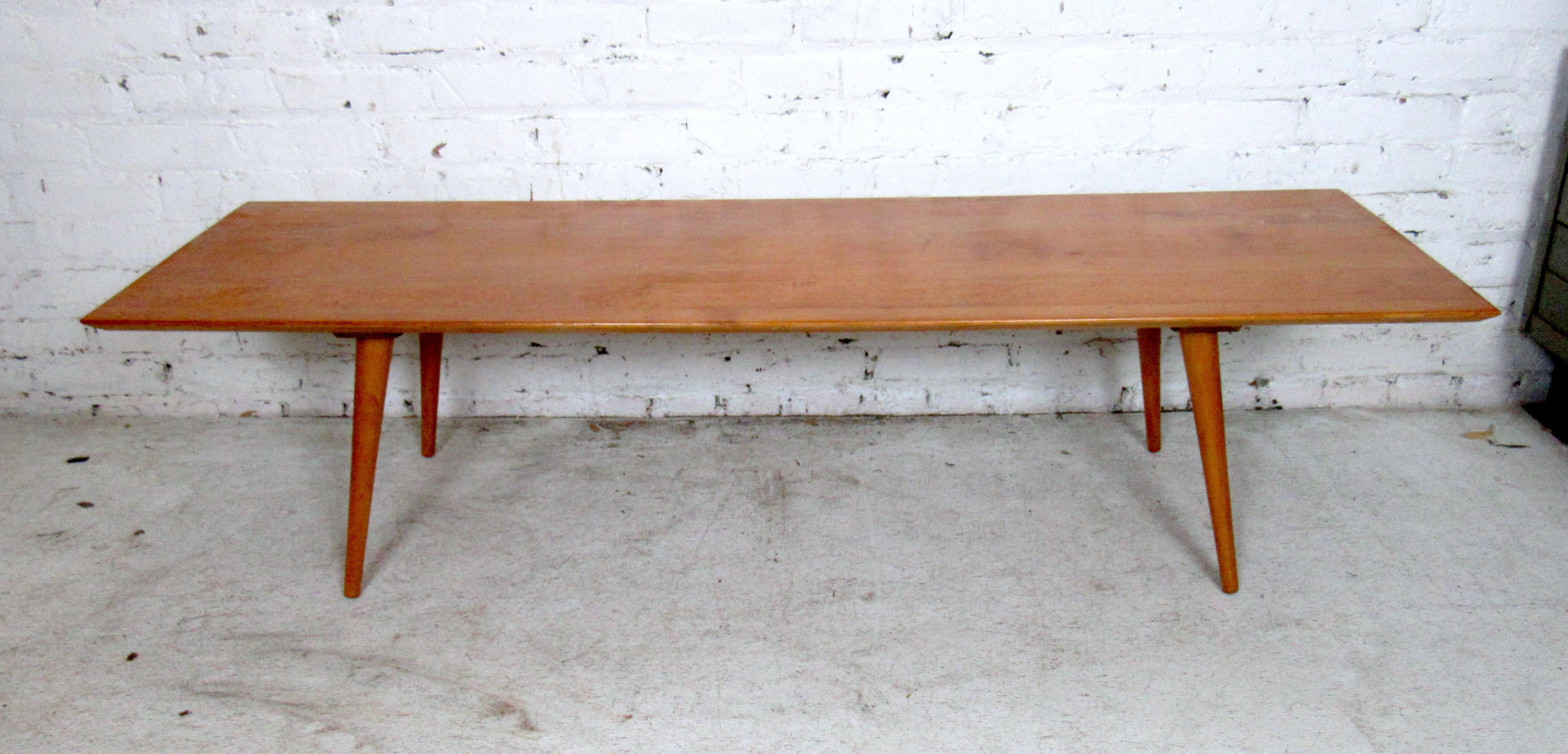 Vintage modern coffee table by Paul McCobb features an elongated rectangle top with splayed tapered legs.

Please confirm the item location (NY or NJ).