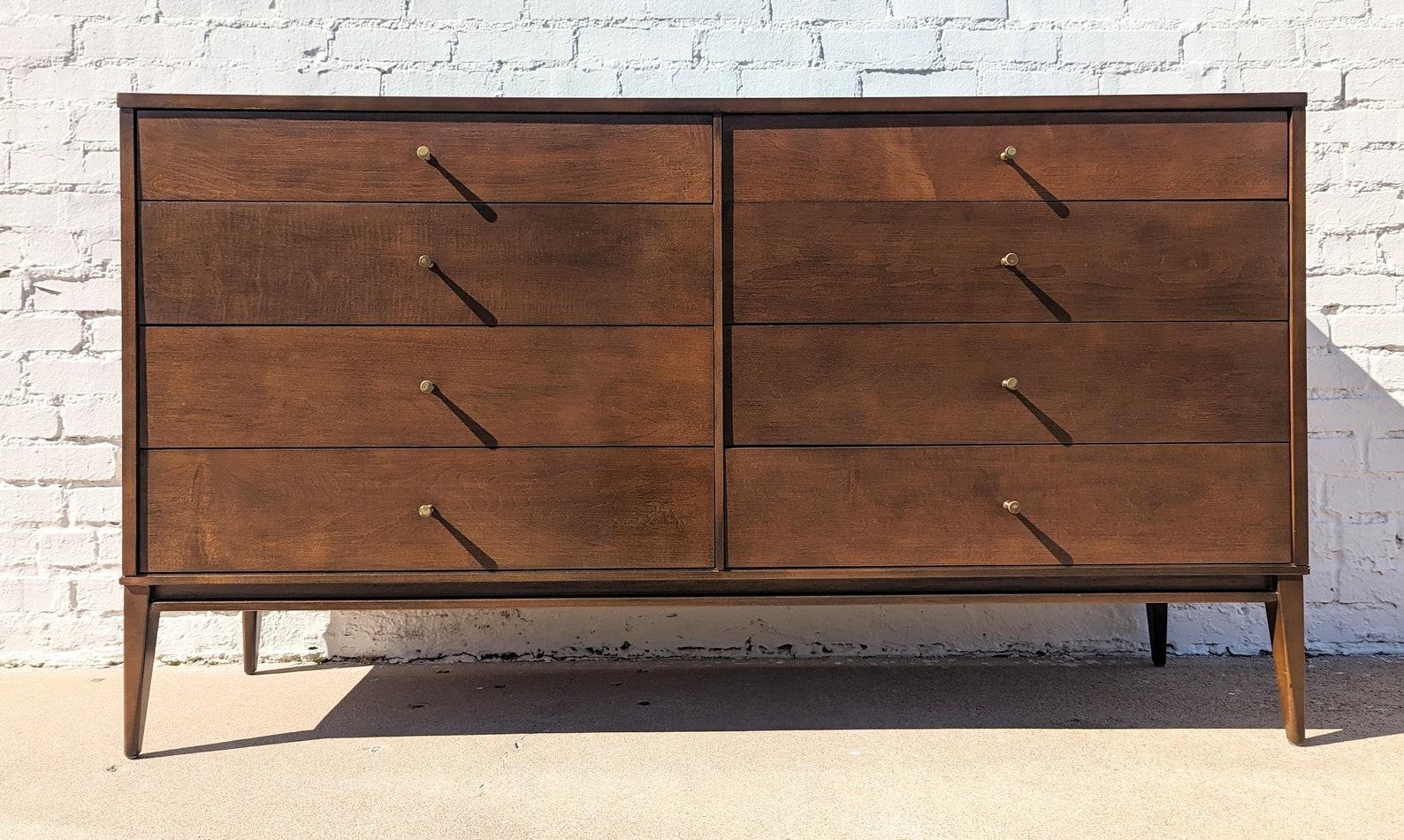 Mid Century Modern Paul McCobb Eight Drawer Dresser
 
Above average vintage condition and structurally sound. Has some expected slight finish wear and scratching. Has a couple small dings and discolorations on top. Two mitered trim edges on the