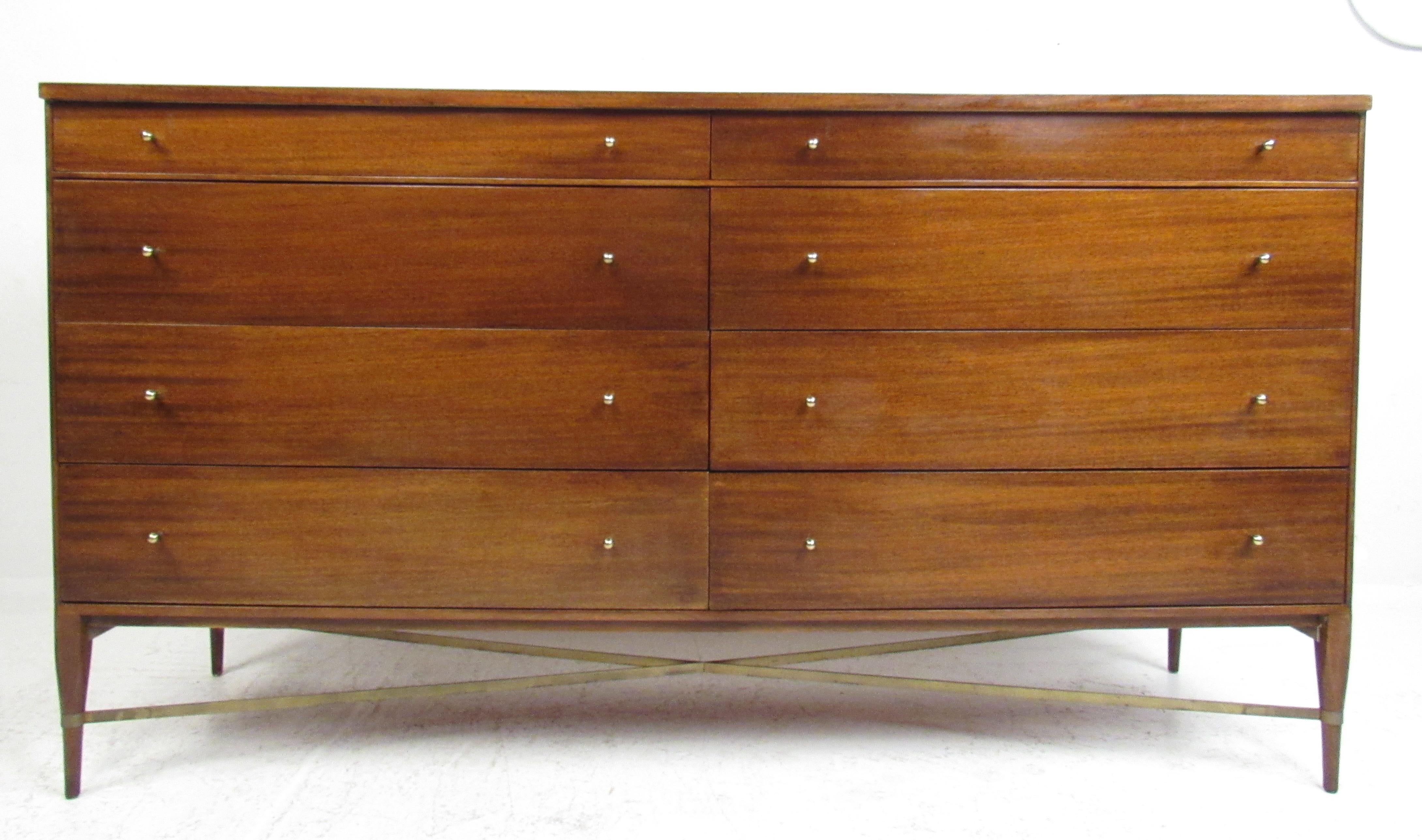 Vintage midcentury Paul McCobb eight-drawer dresser for Calvin Group. Stunning dresser by Paul McCobb made in the 1950s with iconic brass pulls and brass stretchers that form an 