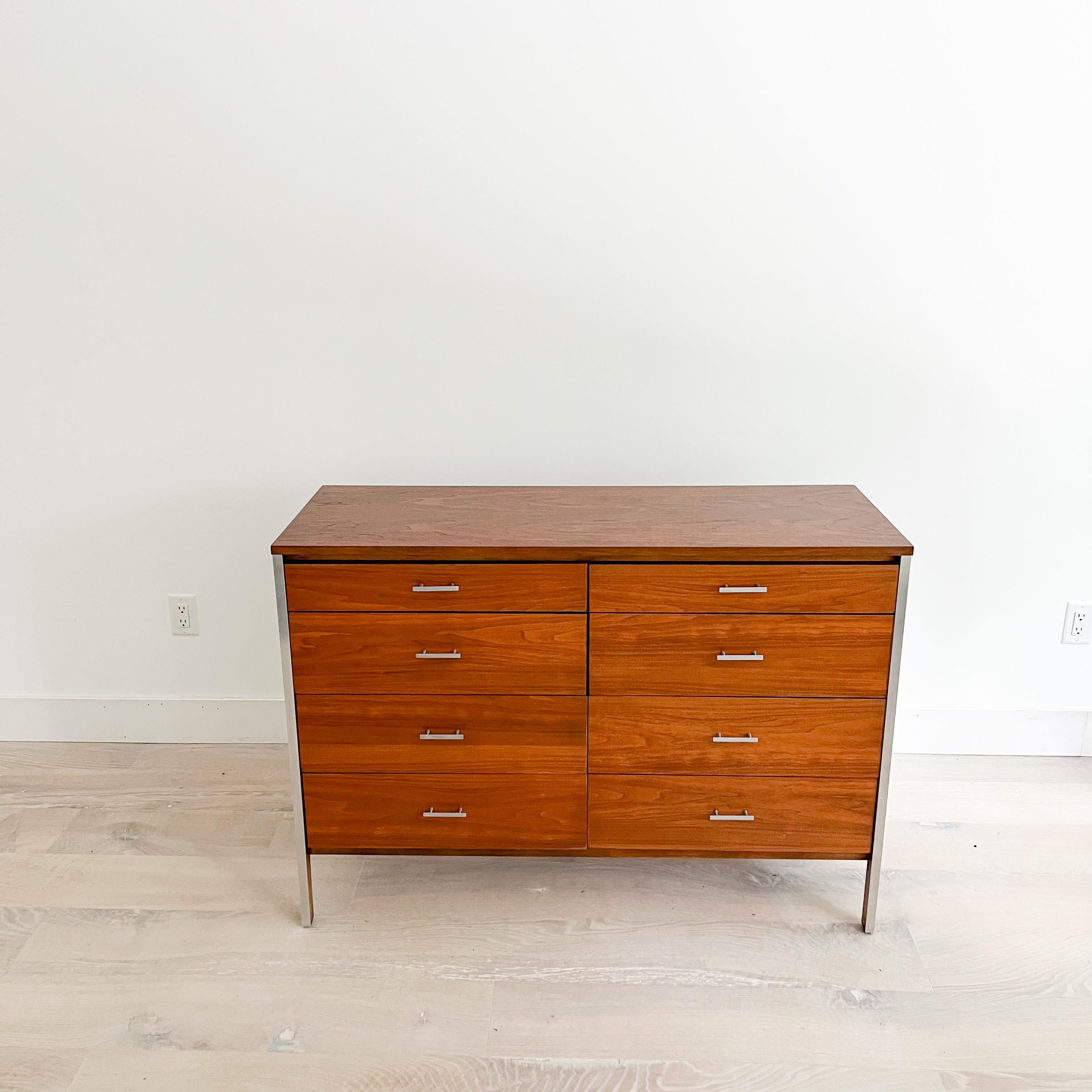 Mid-Century Modern 8 drawer walnut dresser with aluminum accents designed by Paul McCobb for Calvin. The top and drawer fronts have been sanded and restored. Some light scuffing/scratching/small areas of veneer repair from age appropriate wear.