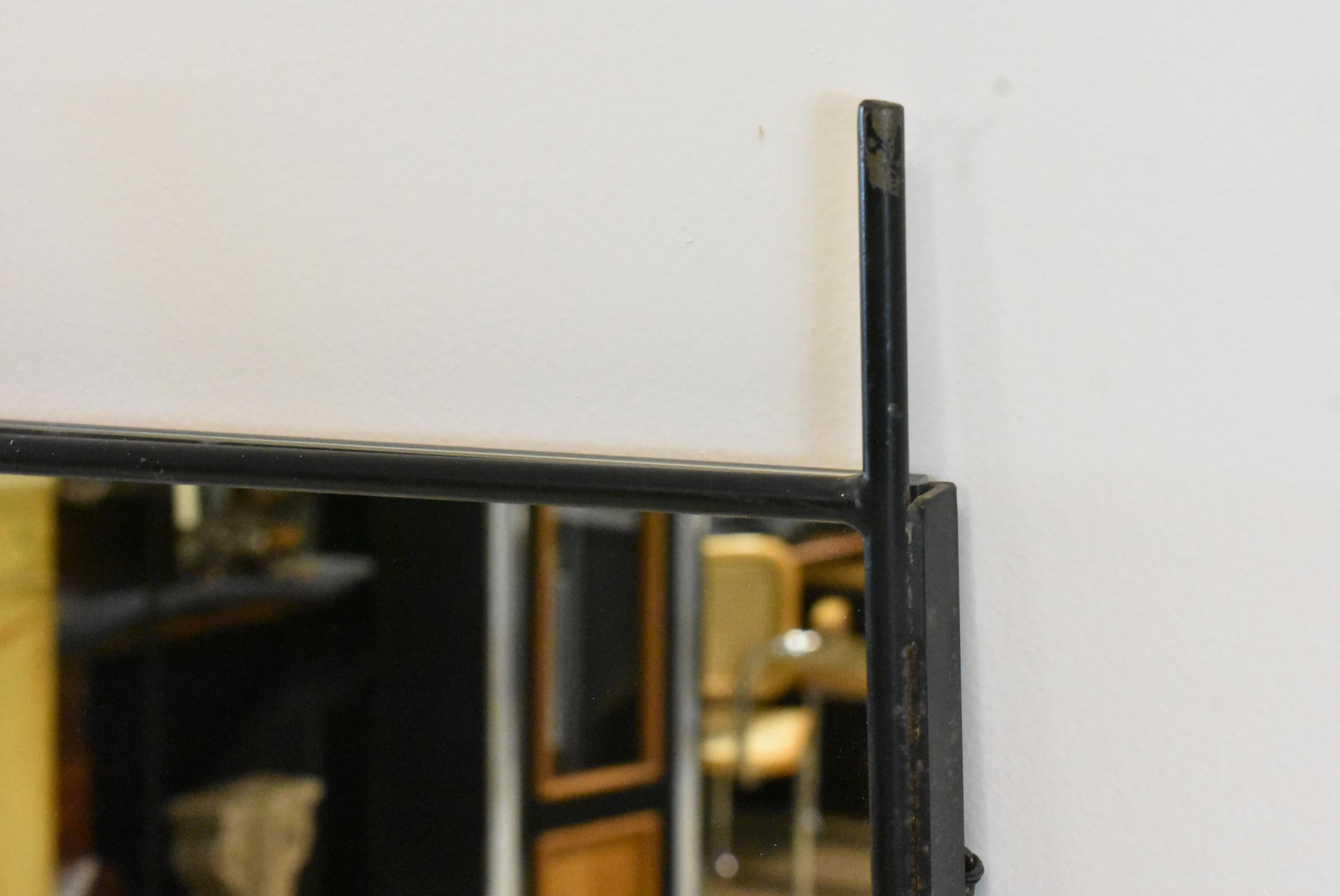 Mid-Century Modern welded iron framed mirror by Paul McCobb. Very good condition. Dimensions: 1