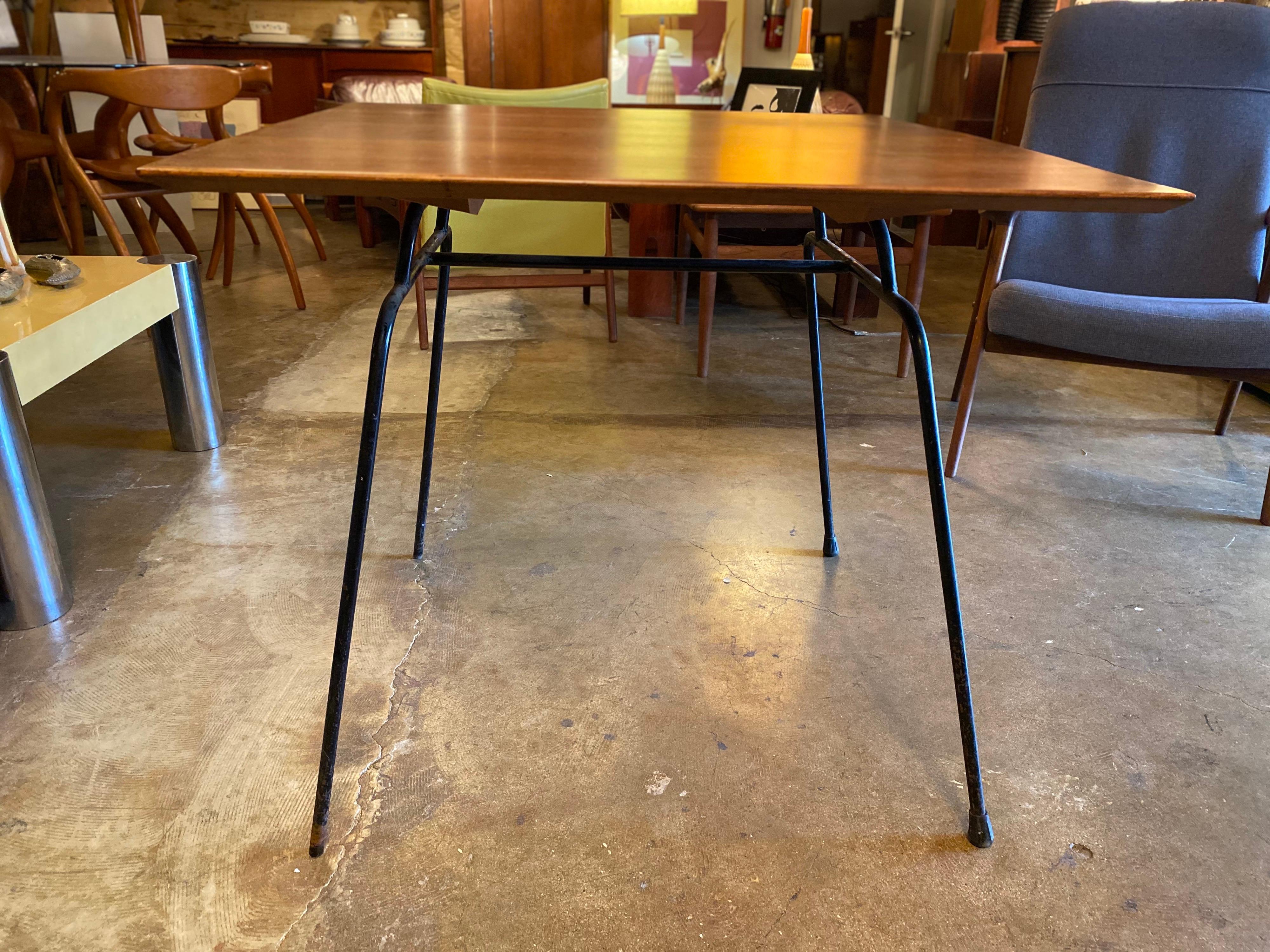 A unique Mid-Century Modern occasional table by Paul McCobb features a maple top with wrought iron frame and legs, circa 1950s. Great for a breakfast table or dining table for a small space. Aesthetic and functional, this vintage table can seat up