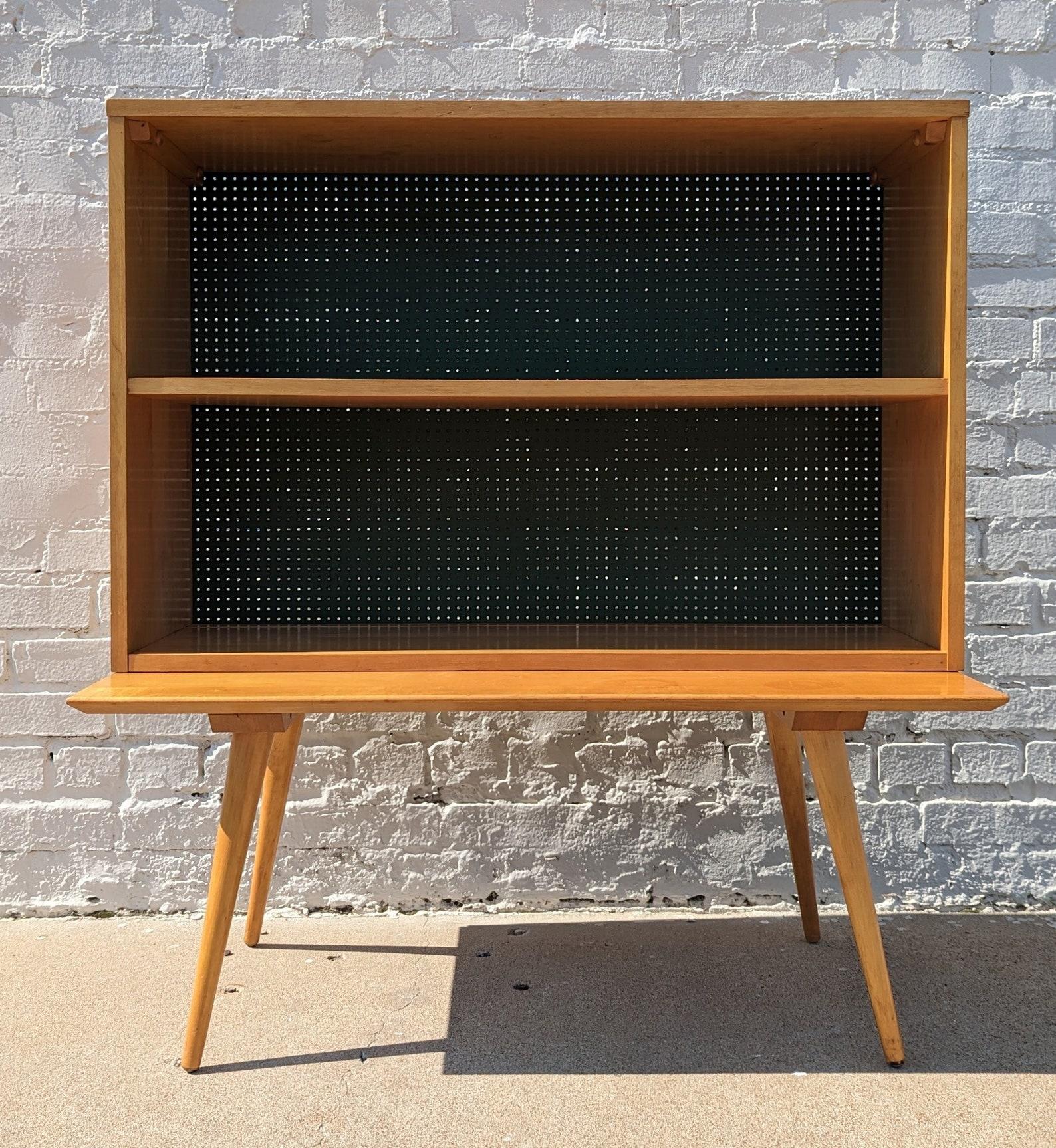 Mid Century Modern Paul McCobb Planner Group Modular Cabinet

Above average vintage condition and structurally sound. Has some expected slight finish wear and scratching. Has a couple small dings and discolorations on top. Table has some rings on
