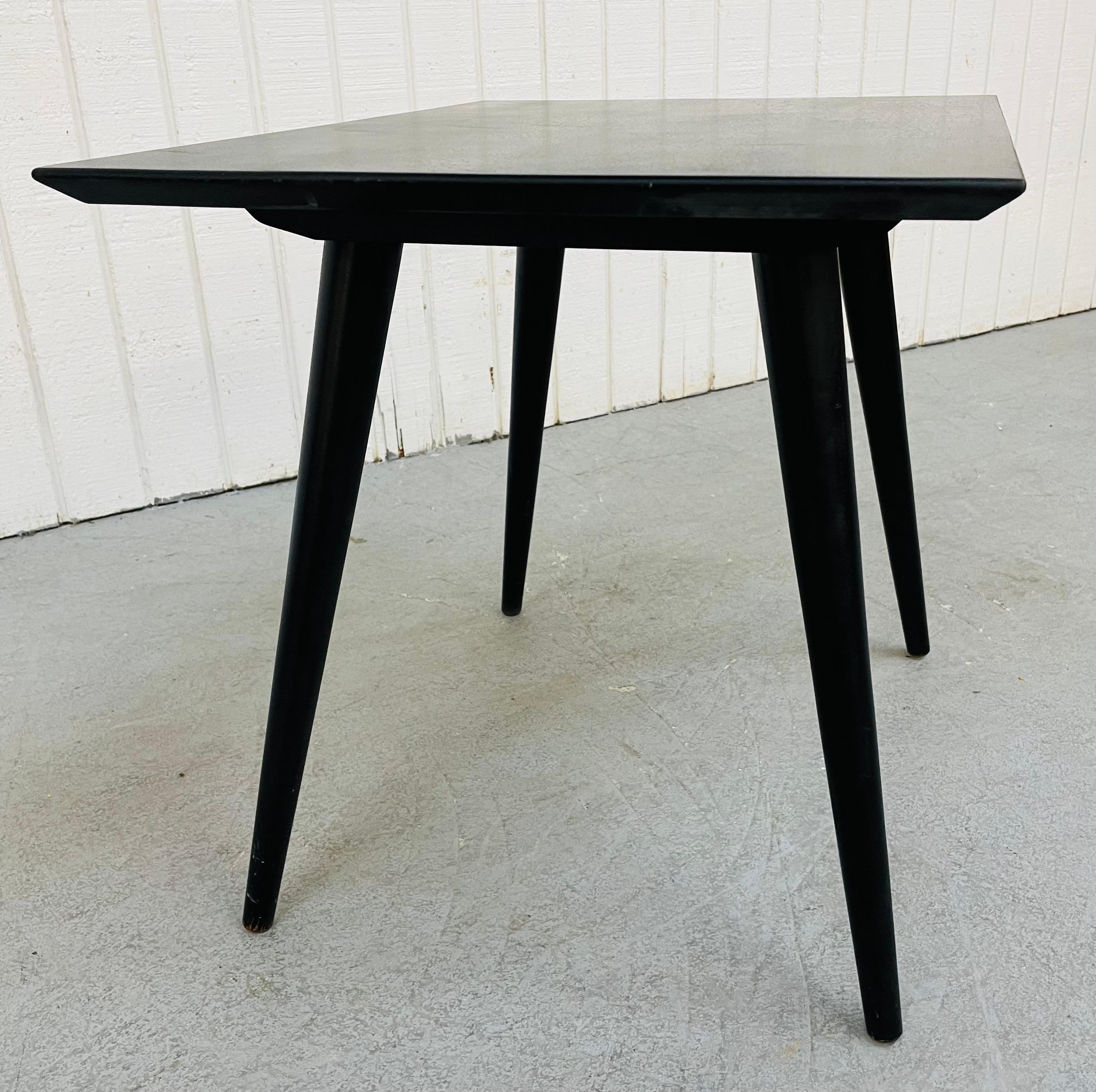 This listing is for a Mid-Century Modern Paul McCobb Planner group side table. Featuring a rectangular top, four long modern legs, and a fresh black painted finish.
