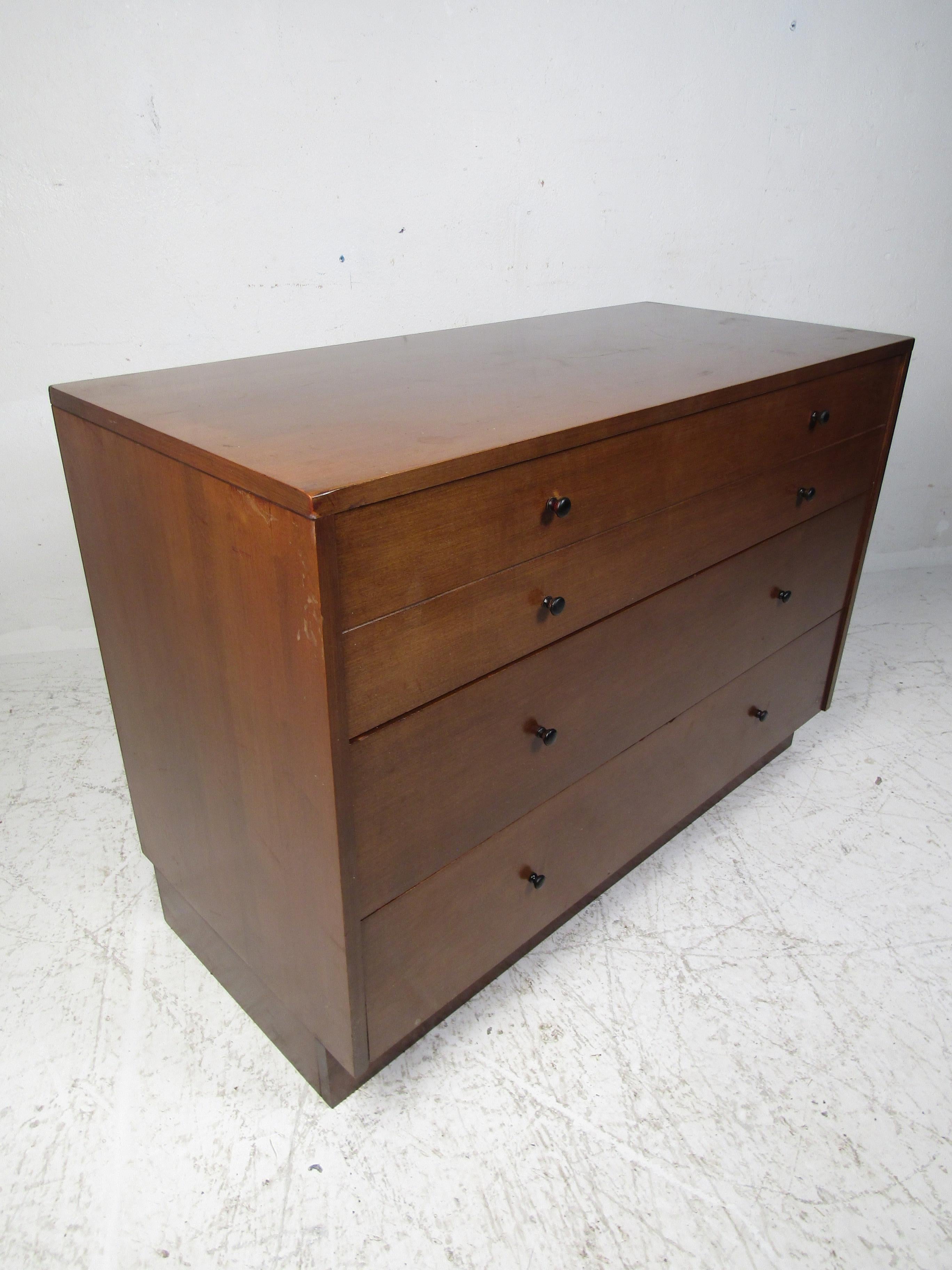 This stunning vintage modern chest offers plenty of room for storage within its four hefty drawers. A straight line design with beautiful walnut wood grain and sculpted drawer pulls. This chest makes the perfect addition to any modern interior.