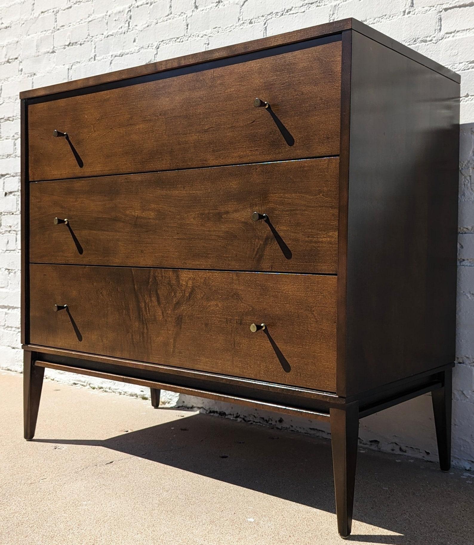 Mid Century Modern Paul McCobb Three Drawer Dresser
 
Above average vintage condition and structurally sound. Has some expected slight finish wear and scratching. Outdoor listing pictures might appear slightly darker or more red than the item does