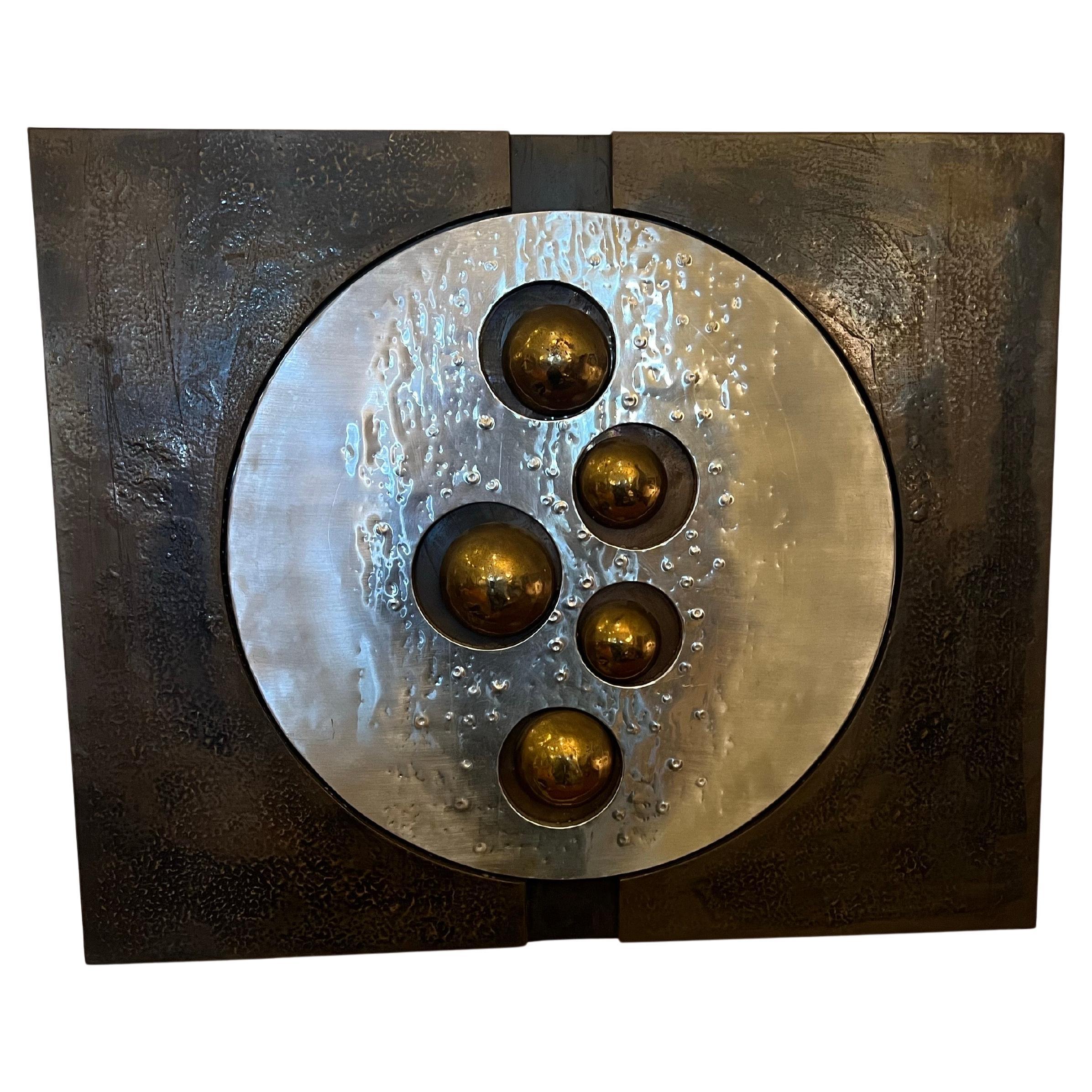 A unique metal wall hanging from artists Paul Vanders oftenn attributed to Adrian Pearsall. This brutalist wall sculpture is composed of shaped aluminum with textural dots and lines, as well as spirals of bronze painted aluminum. Initials can be