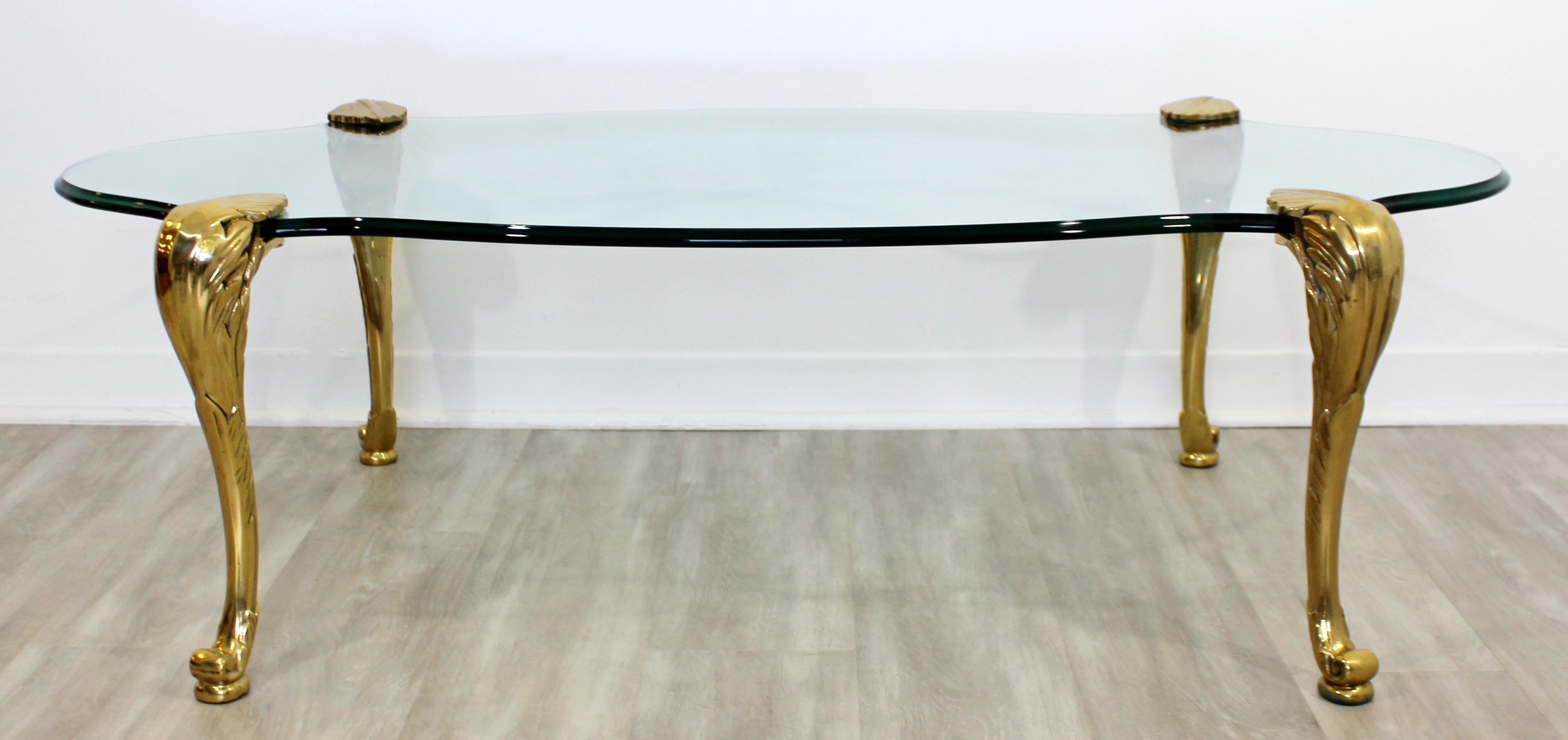 For your consideration is a phenomenally sculptural, brass and glass coffee table, attributed to P.E. Guerin, circa 1950s. In excellent vintage condition. The dimensions are 55
