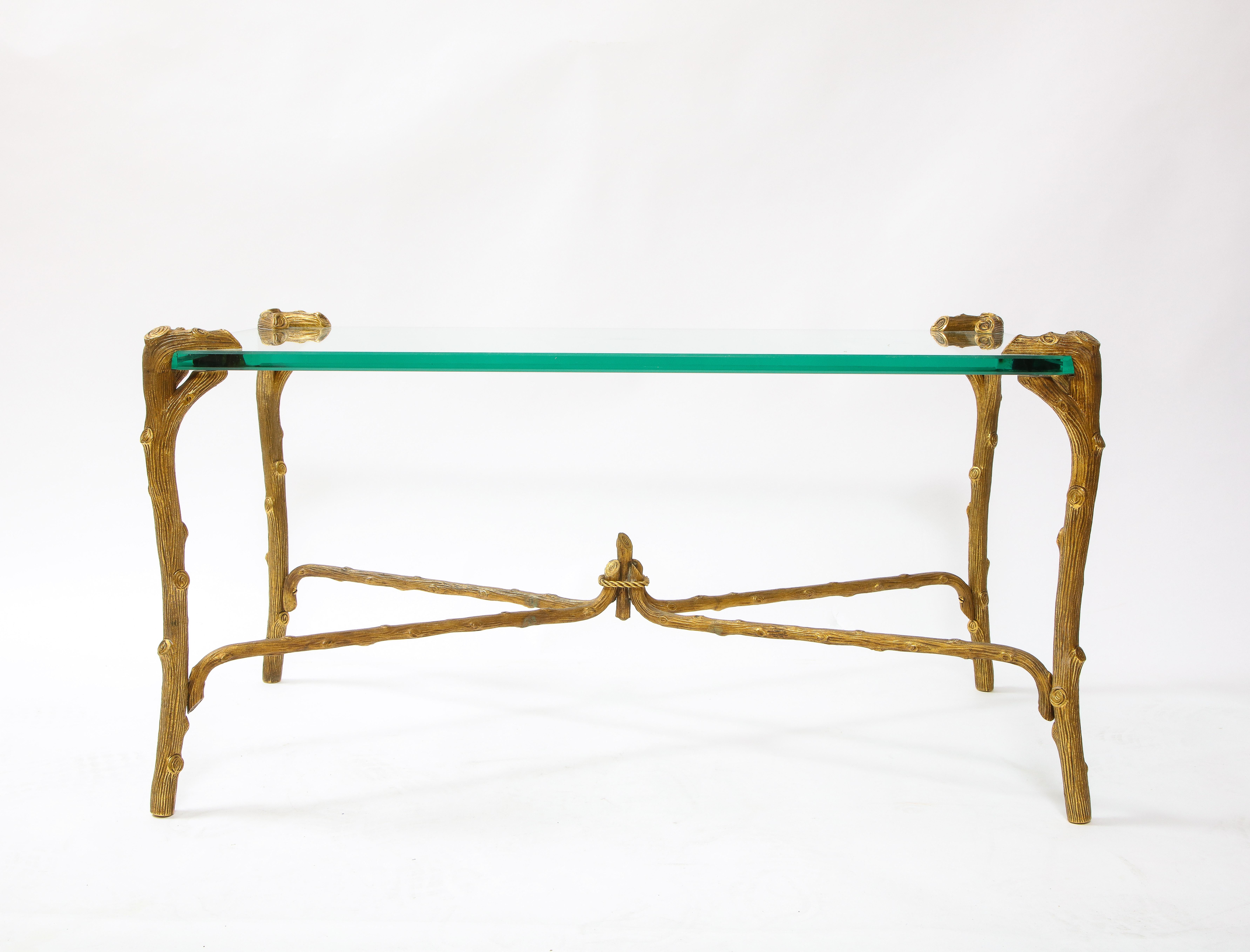 A fabulous Mid-Century Modern P.E. Guerin Faux bois gilt bronze coffee table/center table with stretcher, signed. The top is a rectangular plate glass with gilt bronze stretcher base in the form of wood. The bottom is signed, E. Guerin, New