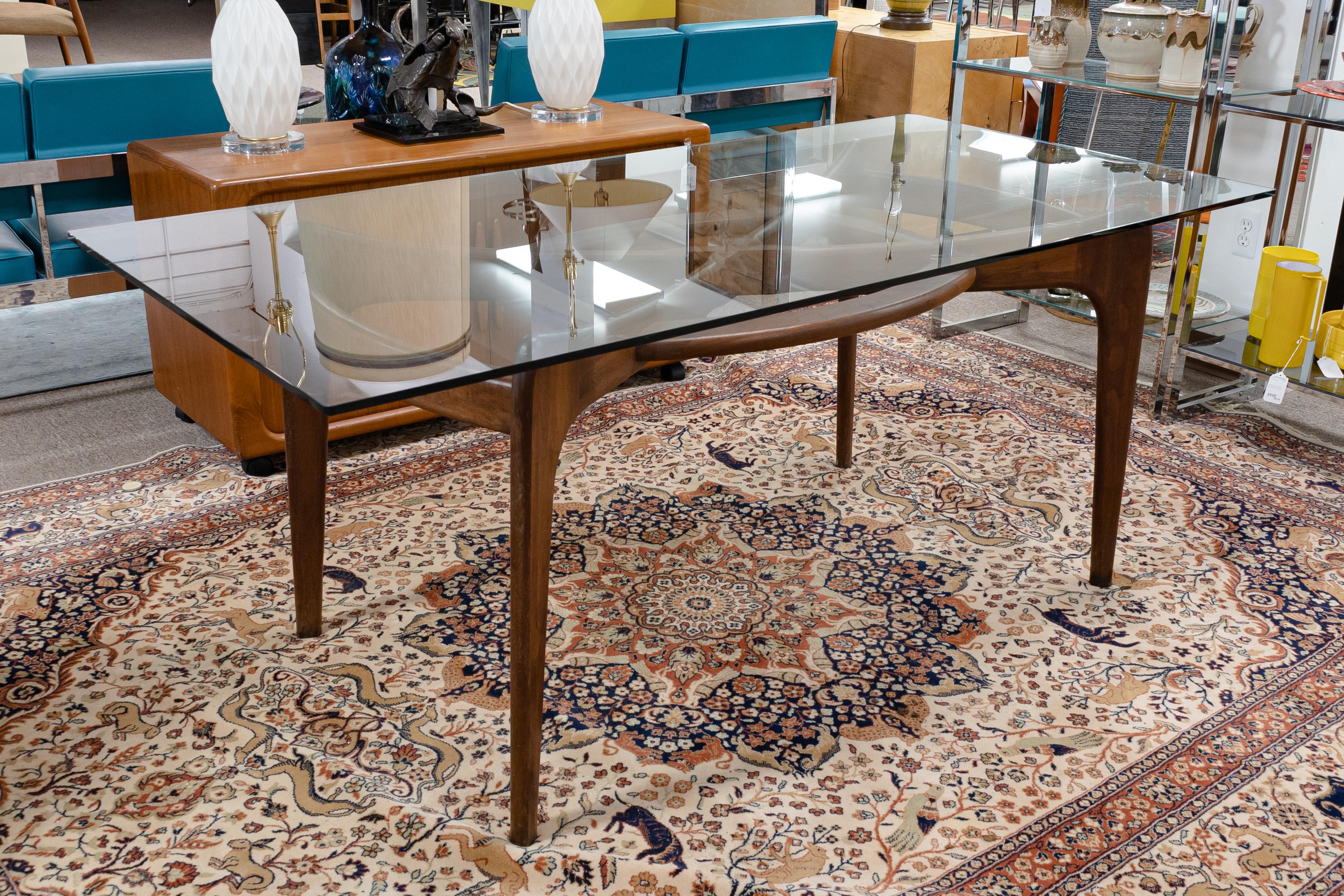 This set includes a very stunning Adrian Pearsall compass dining table and a set of 5 Vladimir Kagan dining chairs. This table features a crystal clear glass table top, and a very well made wood frame with compass design. The table top is unattached