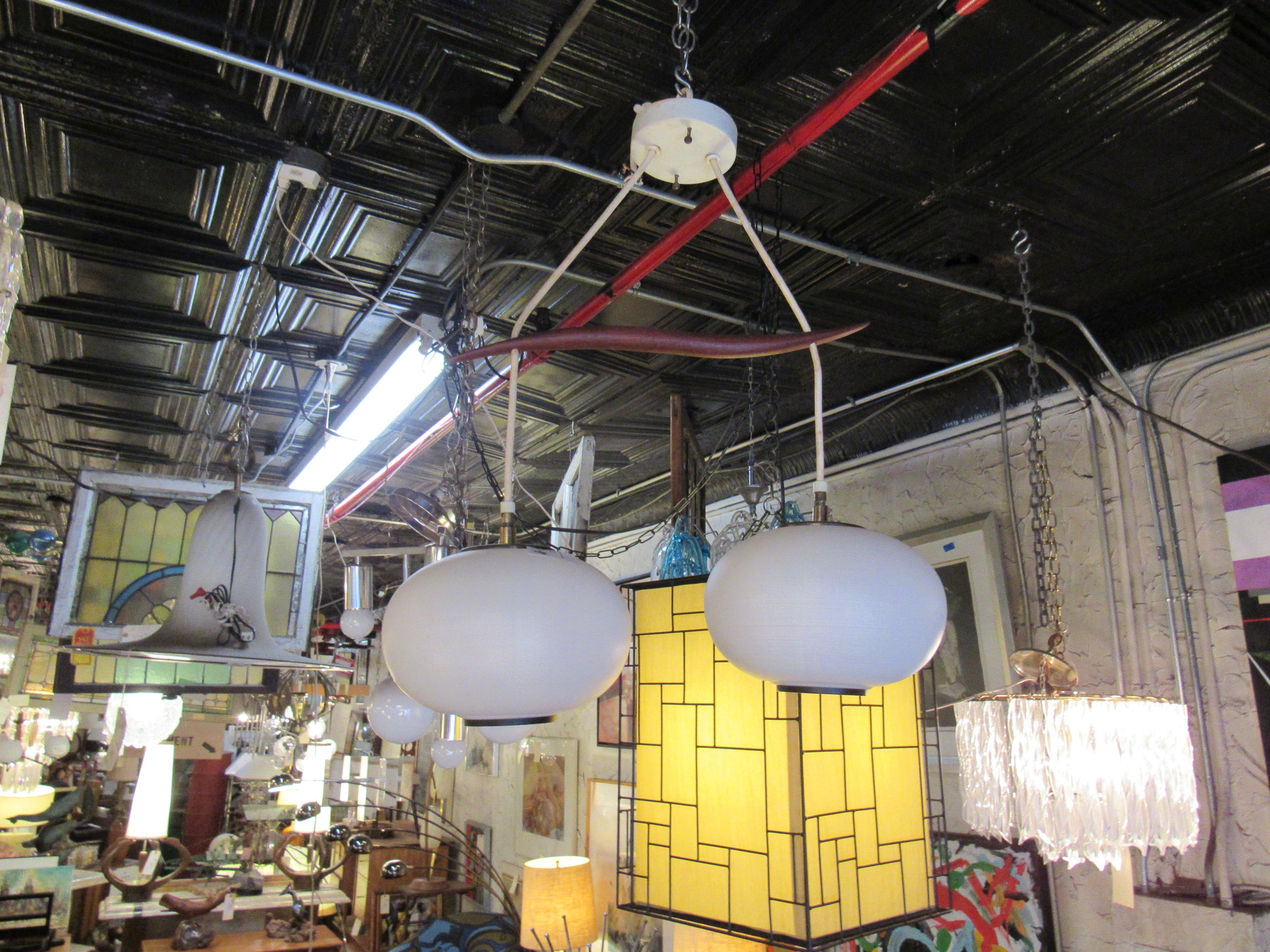 With two large globes and a connecting strip of wood, this vintage pendant is a Mid-Century Modern gem. 
Please confirm item location with seller (NY/NJ).