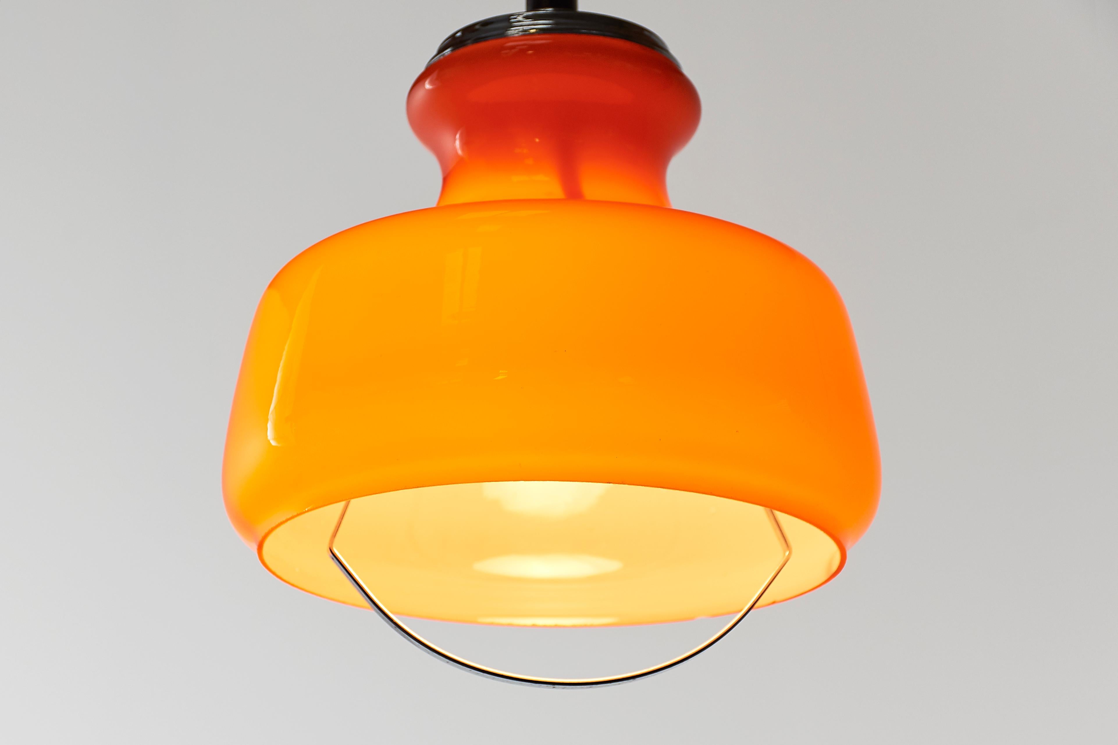 Chic with the vibe of midcentury Organic Modern cool. This orange opaque Murano glass pendant lamp has sumptuous curves, elegant chrome-plated accents including a 