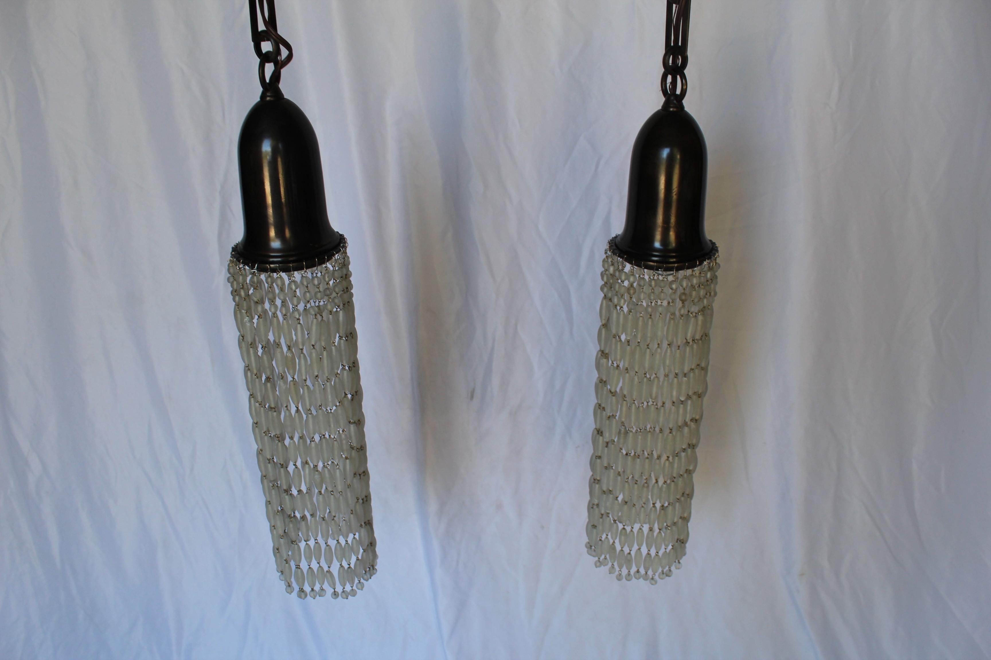 Custom designed and custom made brass Pendants with hand Tied frosted glass beads, Bell shape shade holder is finished in bronze patina. It is 5 1/2