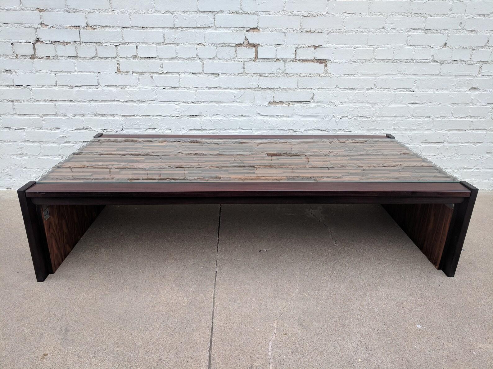 Mid Century Modern Percival Lafer Brutalist Rosewood Coffee Table

Above average condition and structurally sound. Wood is in very good condition. Some small areas with slight fading the wood.

Additional information:
Materials: