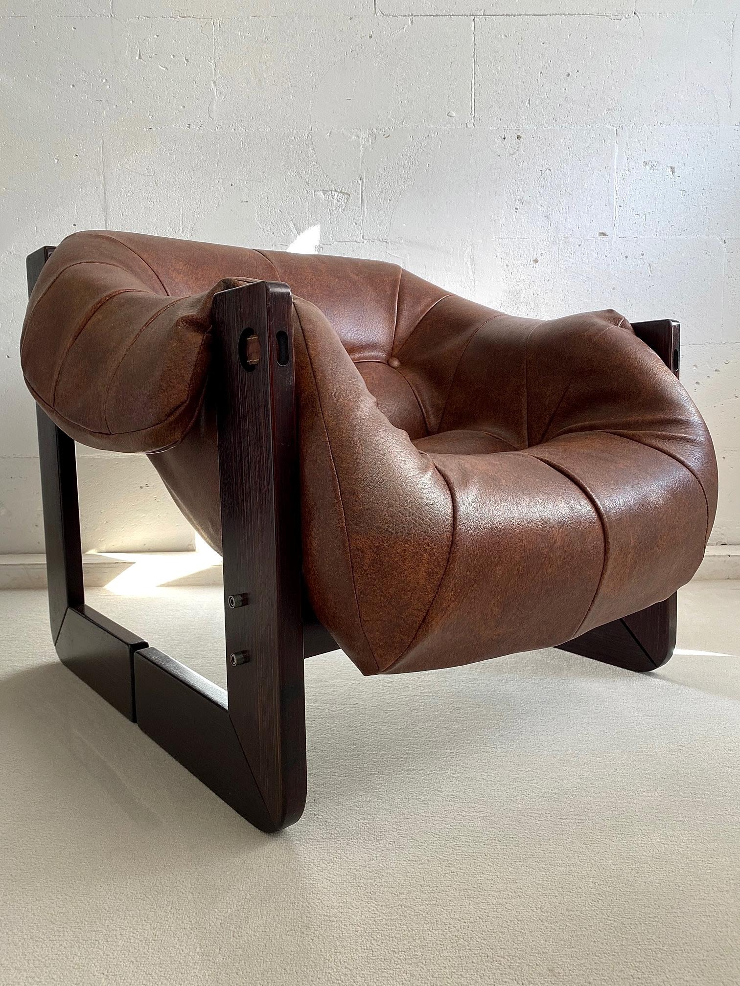 Percival Lafer super comfortable Mid-Century Modern lounge chair made of Brazilian mahogany and still with it's original faux leather upholstery. This beauty has it's original leather support straps and dowels. The split wooden legs and unusual