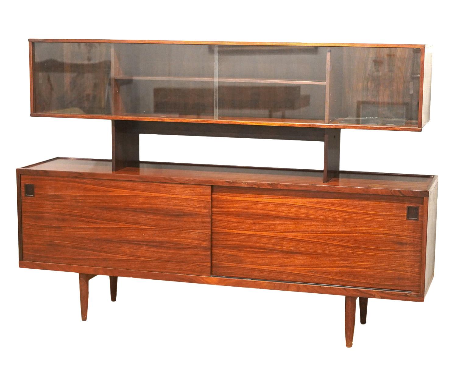 Mid Century Modern Peter Lovig Nielson Danish Rosewood Sideboard Credenza. Top has glass doors to use as a display cabinet. Bottom is hidden storage with shelves and doors. Top display has two mirrors on shelves that are attached. Minor wear. Couple
