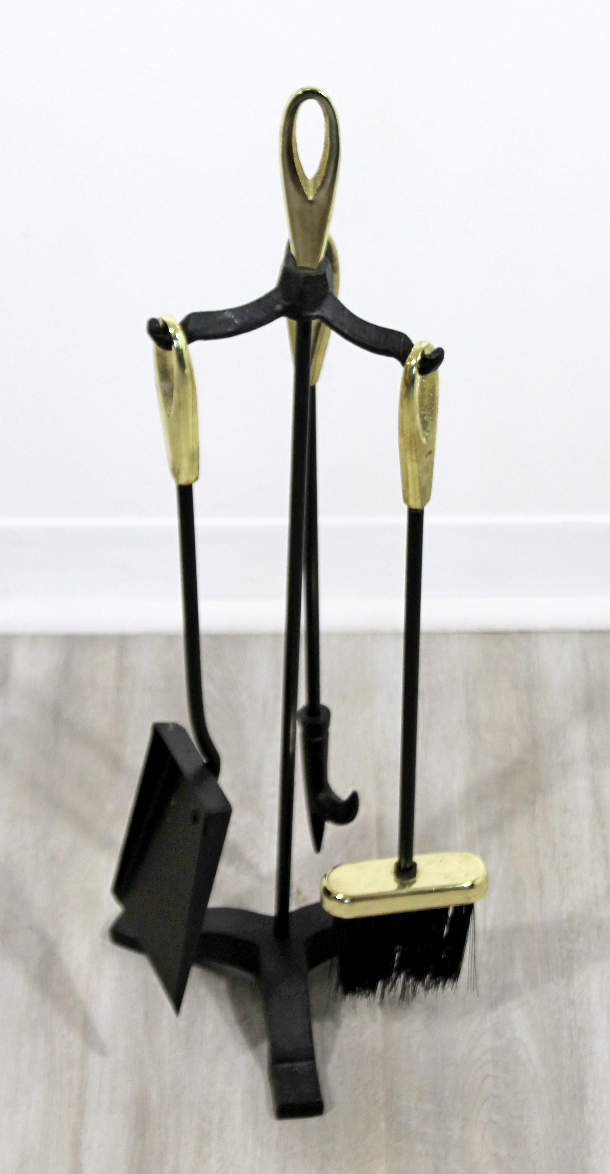 For your consideration is a lovely and petite set of brass & iron fireplace tools, including a shovel, brush and poker, circa 1960s. In very good condition, with a beautiful patina. The dimensions are 9
