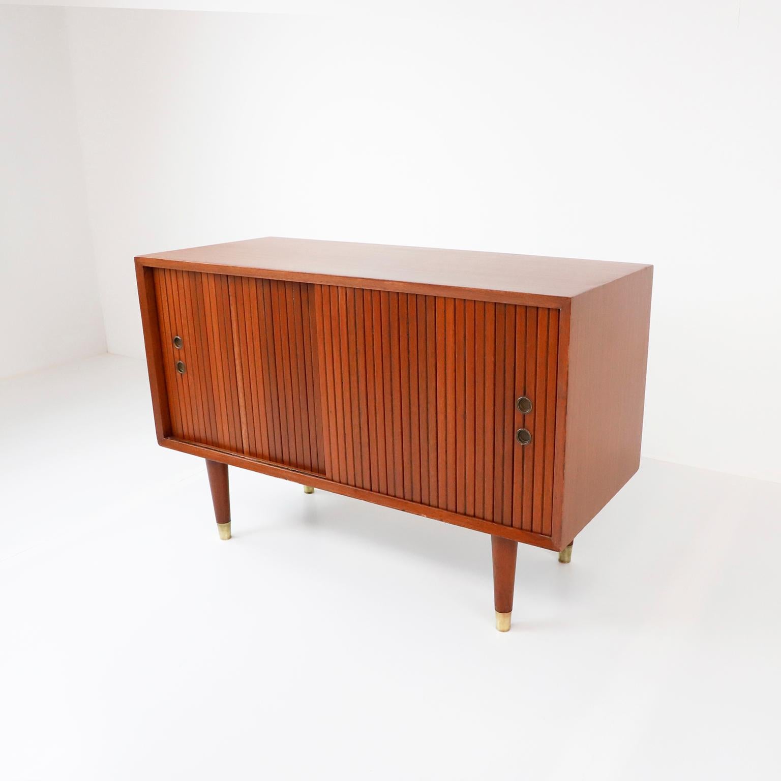 Circa 1970, we offer this Mid-Century Modern petite disc cabinet by Michael Van Beuren, made in mahogany plywood and brass details, includes VB original label.

About Michael Van Beuren:

Michael Van Beuren (1911-2004) was born in New York and