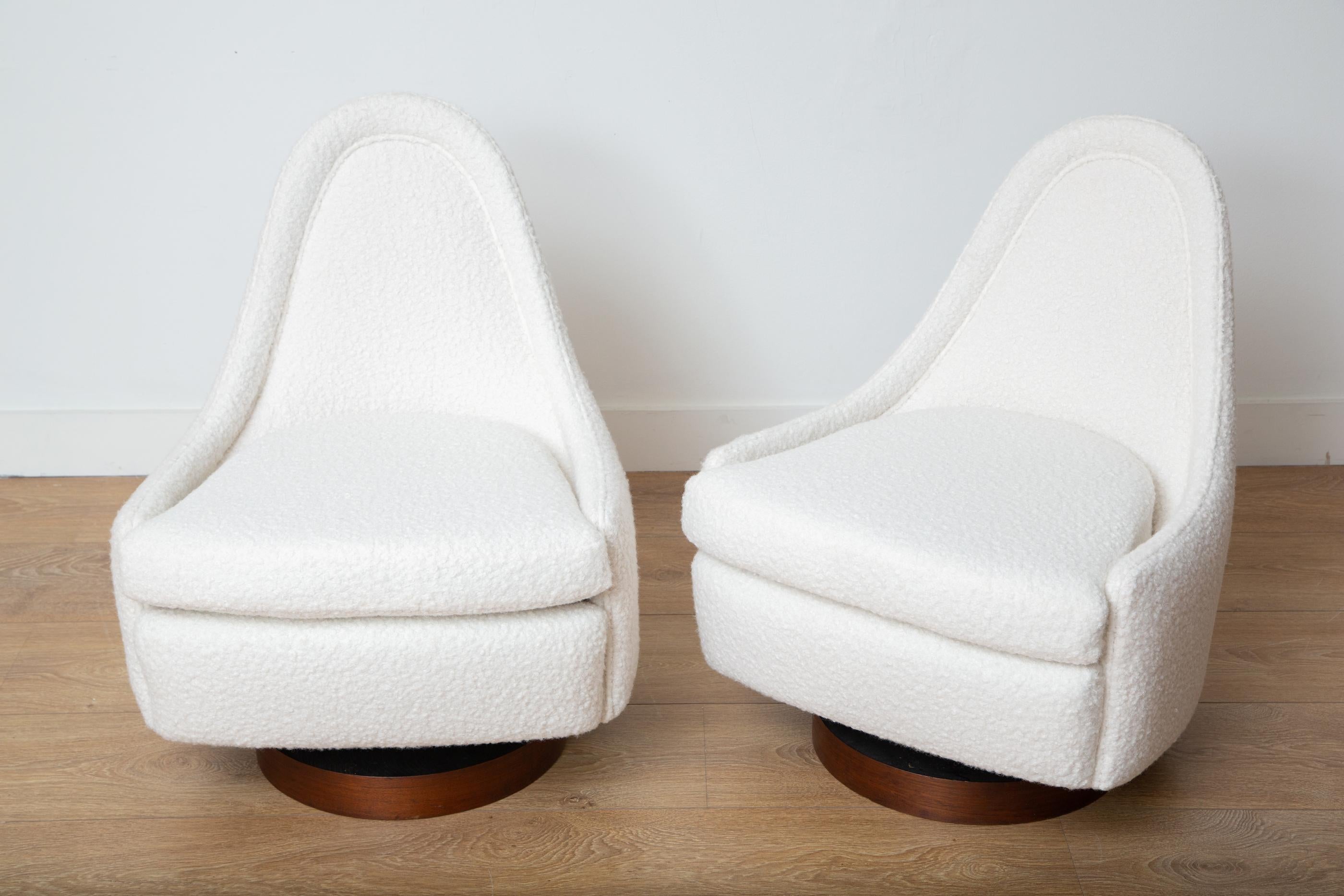 Pair of Mid-Century Modern petite tilt and swivel lounge chairs 
by Milo Baughman for Thayer Coggin
Sculptural teardrop back on a walnut base
Newly upholstered with a cream boucle
4 available, priced per pair
Available to view in-situ in our