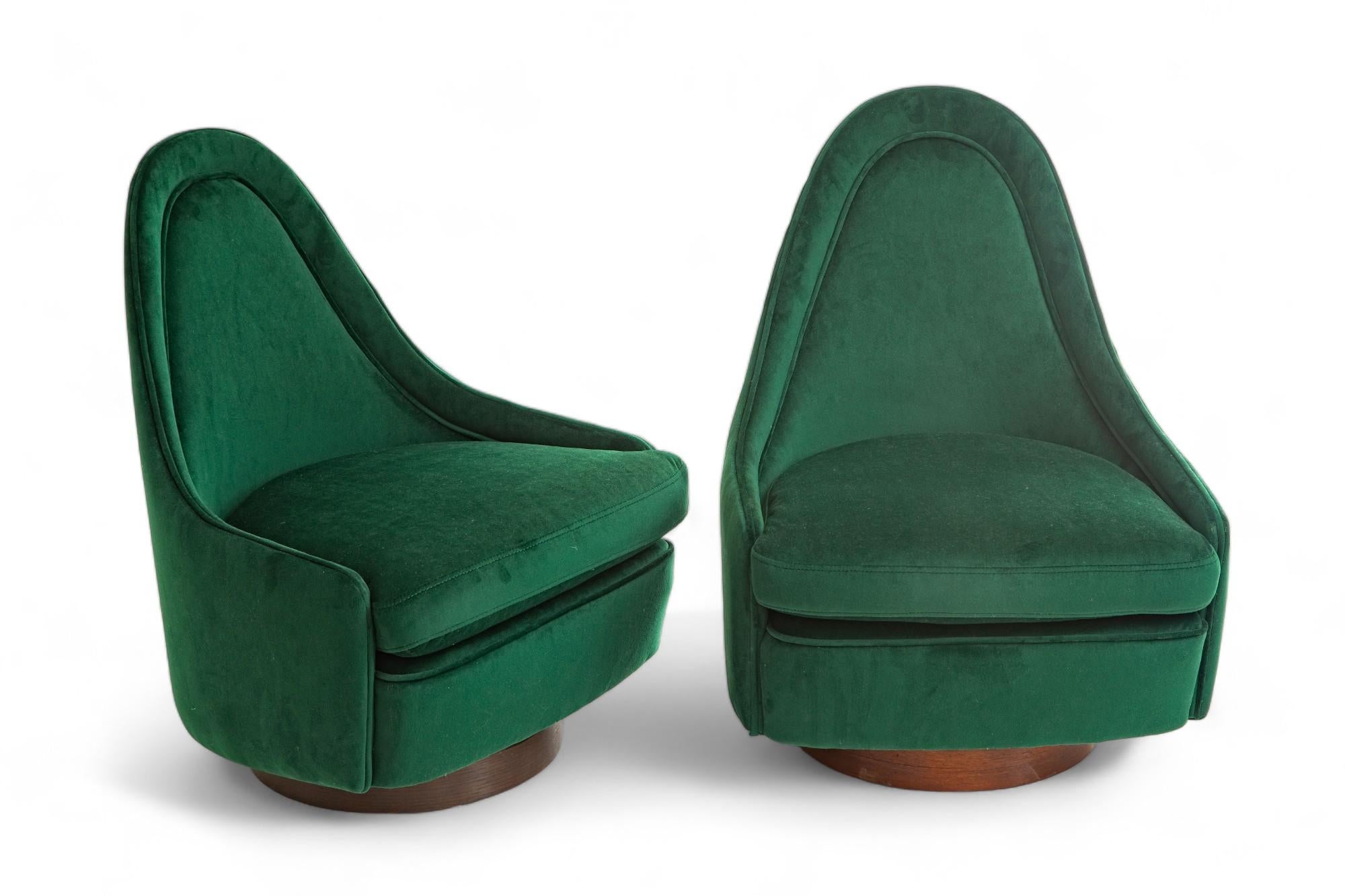 Pair of Mid-Century Modern petite tilt and swivel lounge chairs 
by Milo Baughman for Thayer Coggin
Sculptural teardrop back on a walnut base
Newly upholstered with an emerald green velvet
4 available, priced per pair
Available to view in-situ in