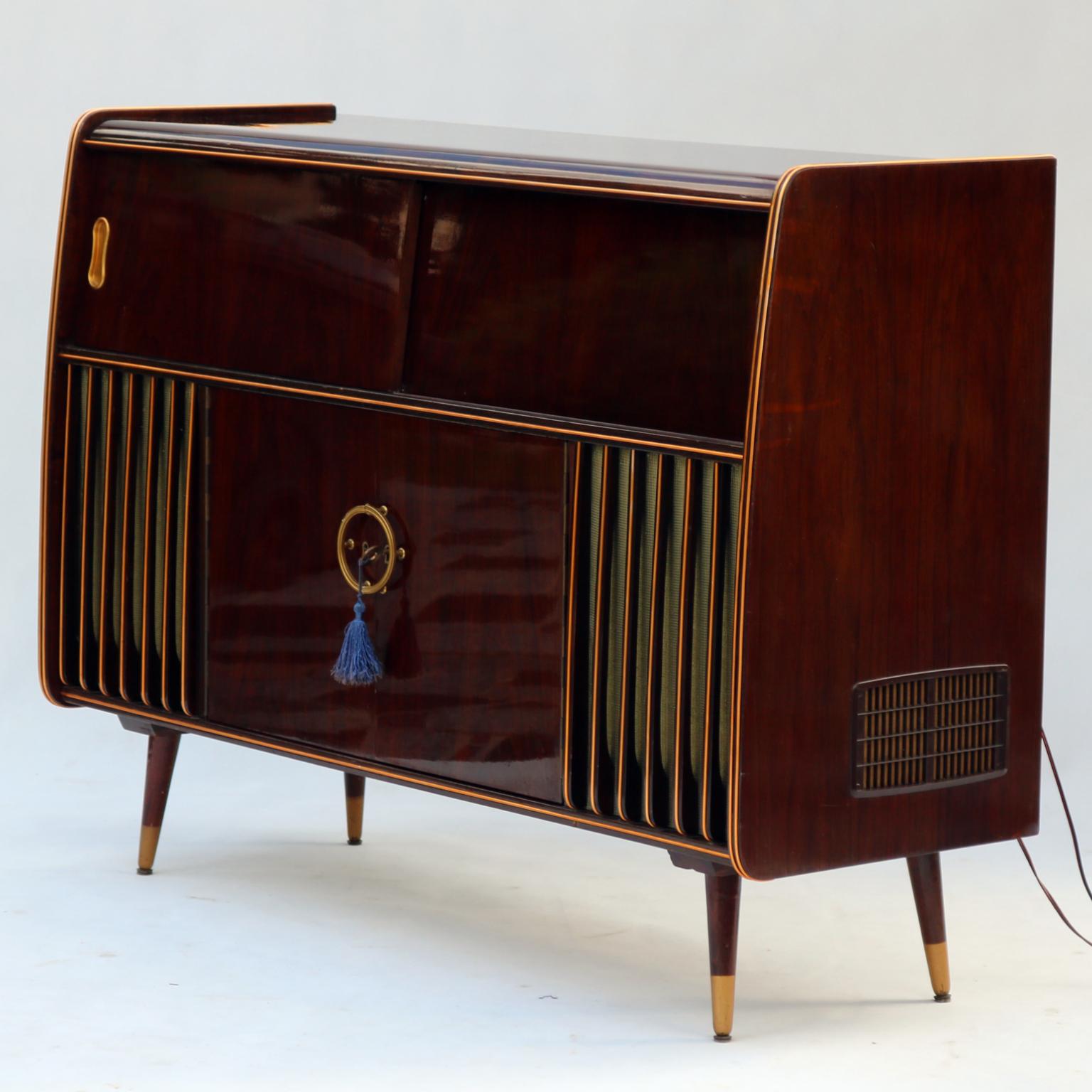 Mid-Century Modern stereo console with radio Orion and cocktail cabinet (with light) in original condition. Everything works as intended including the radio and the phonograph. Looks as great as it sounds.