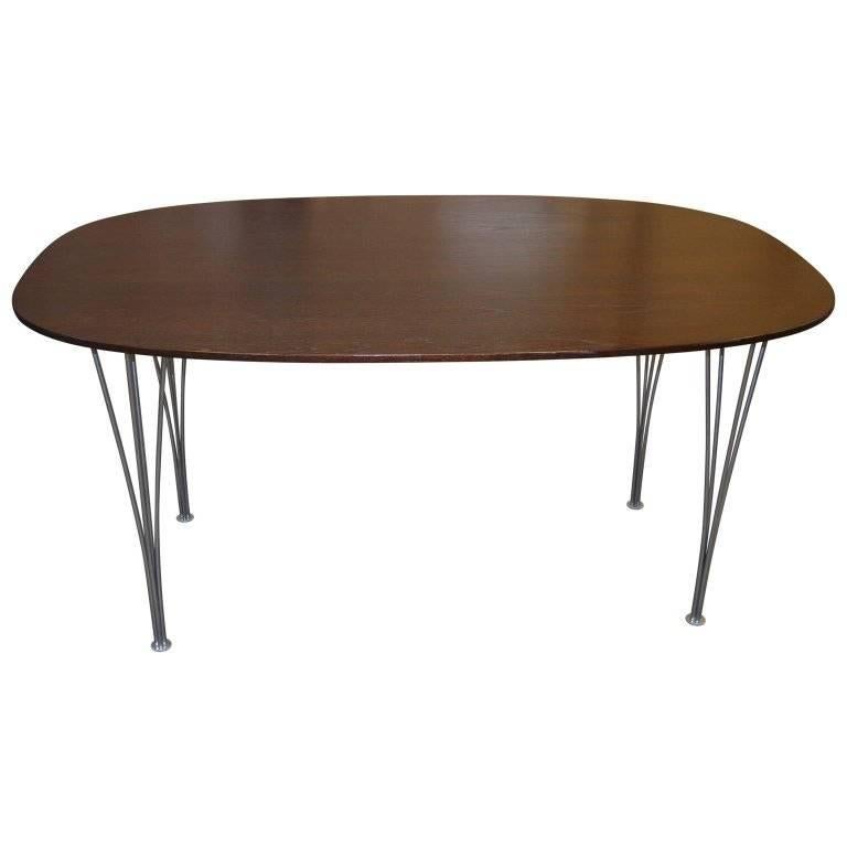 Mid-Century Modern Danish Ellipse dining table with chromed steel legs.
Designed by Piet Hein and Bruno Mathsson for Fritz Hansen, Denmark 1974. This table has glowing wood juxtaposed against the graceful tapered legs. The table easily fits four