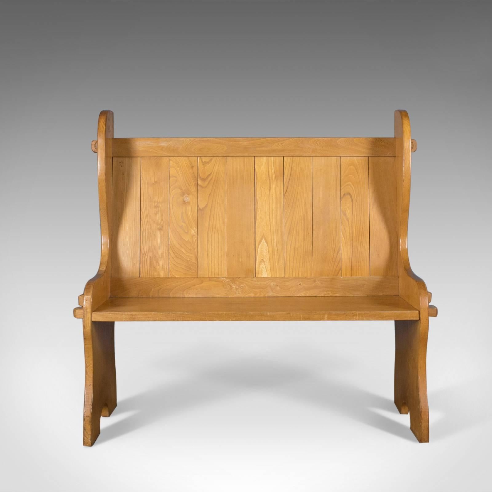 This is a Mid-Century Modern pine settle, an English bench or pew, ideal for the hall, kitchen or boot room.

Solid pine plank construction with a waxed finish
Tongue and groove boards to the back with winged sides
Solid seat slab rising from