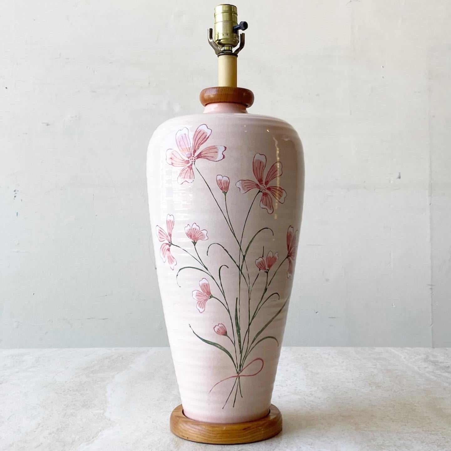 Incredible Mid-Century Modern table lamp. Features hand painted pink flowers over a light pink with a wooden base.
 
