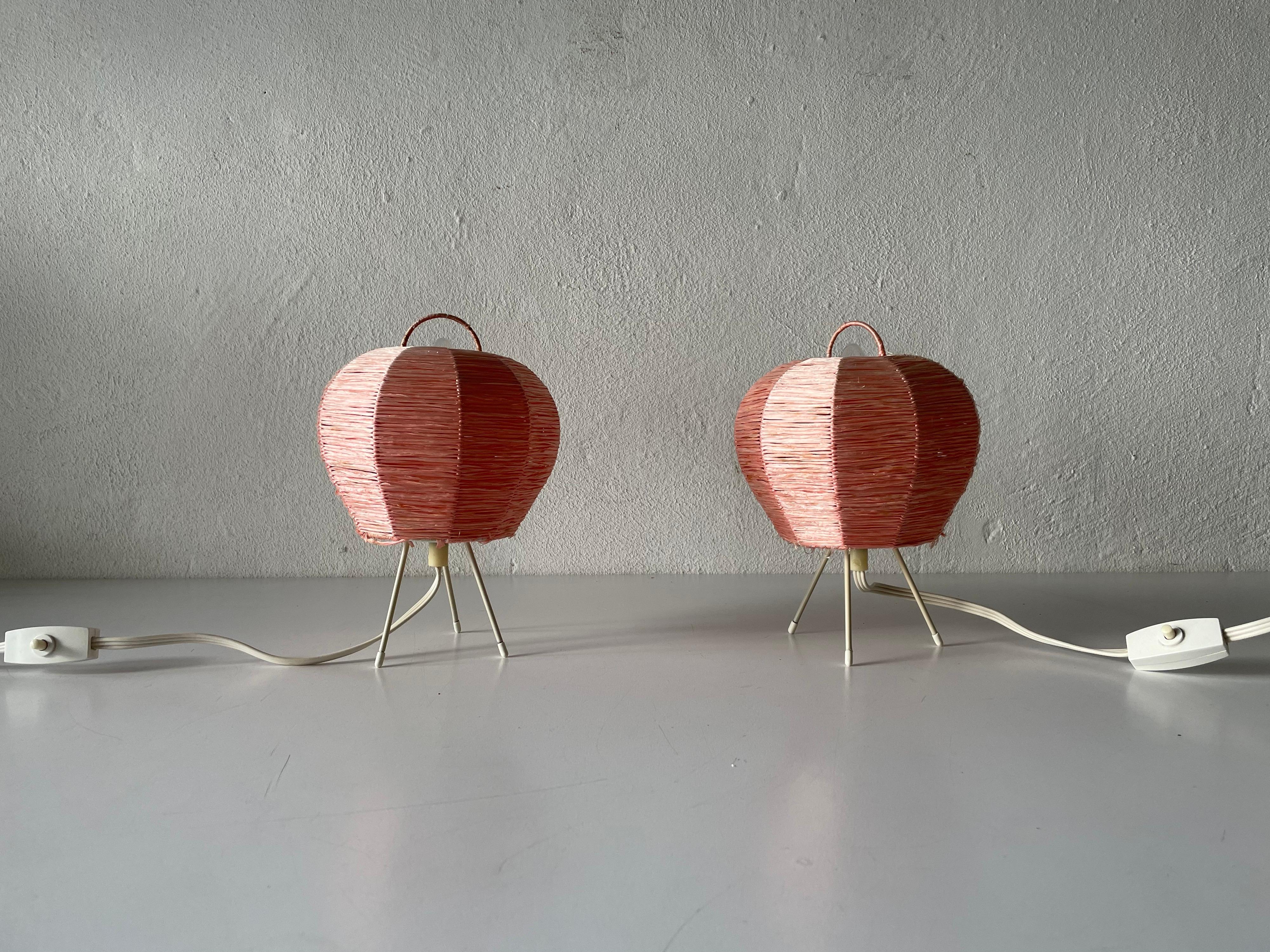Mid century beautiful pink Raffia tripod pair of bedside lamps, 1950s, Germany

Minimal design 
Very high quality.
Fully functional.

Original cable and plug. Switch on-off on the cable. 
This lamp is suitable for EU plug socket. 

Lamps
