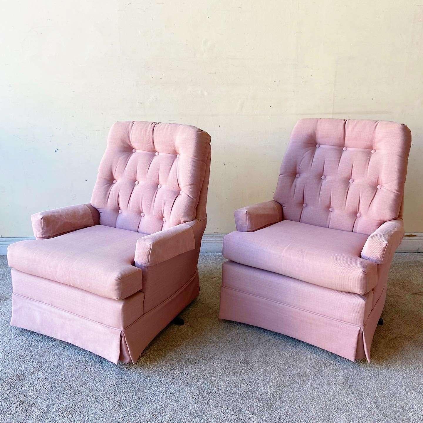 Exceptional pair of vintage mid century modern swivel lounge chairs. Each feature a pink fabric with a tufted back rest.

Seat height is 17.0 in