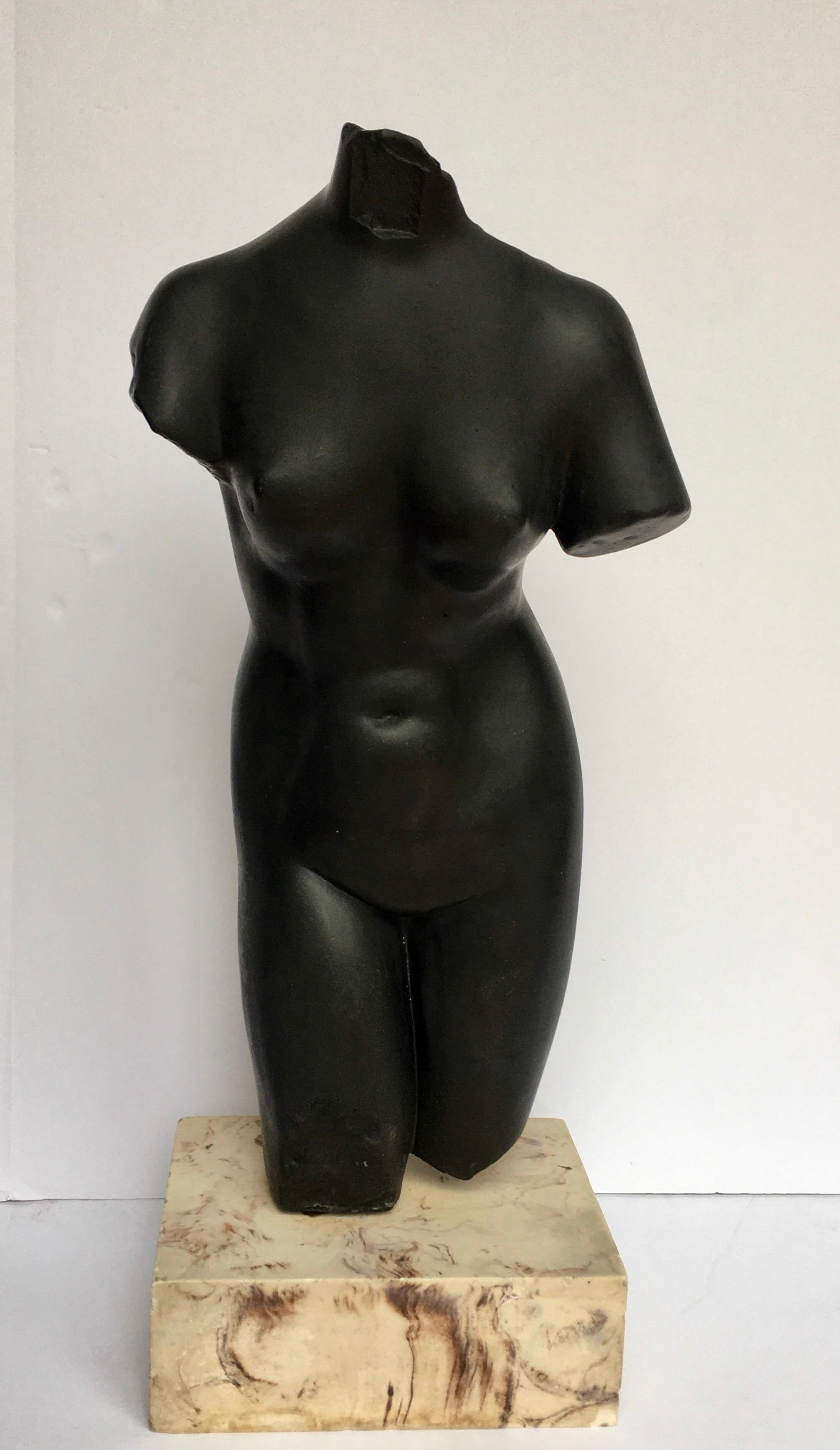 Large Mid-Century Modern female torso sculpture mounted on a solid marble plinth base. Bust is molded from a heavy weight solid black plaster. 