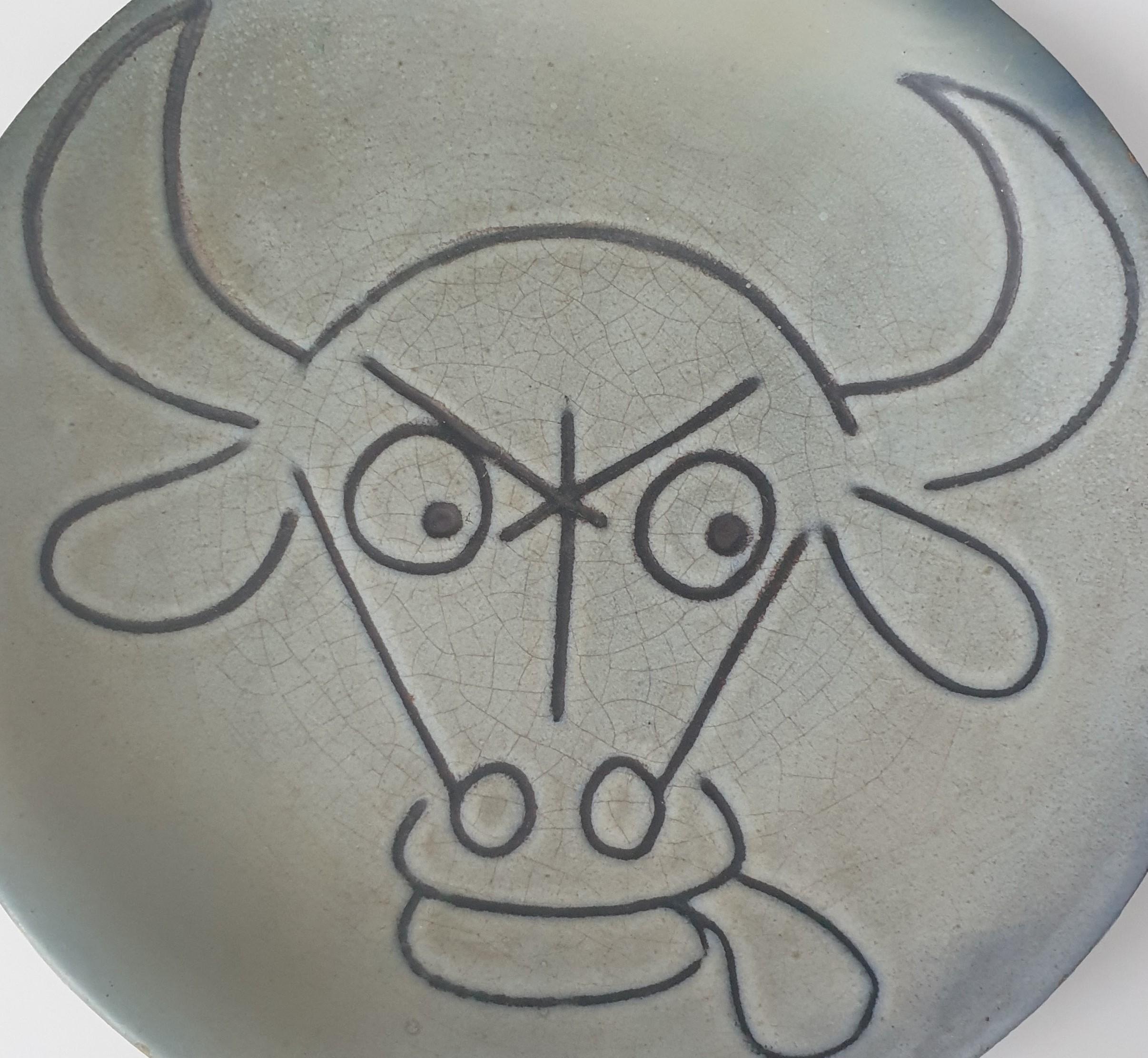 Earthenware plate with matt grey glaze  depicting a bull by the celebrated French ceramicist Robert Picault, Vallauris, South of France. Signed to base. 
THE PLATE IS NOT SOLD WITH THE STAND BUT A STAND COULD BE ORDERED IF REQUIRED FOR A COST OF