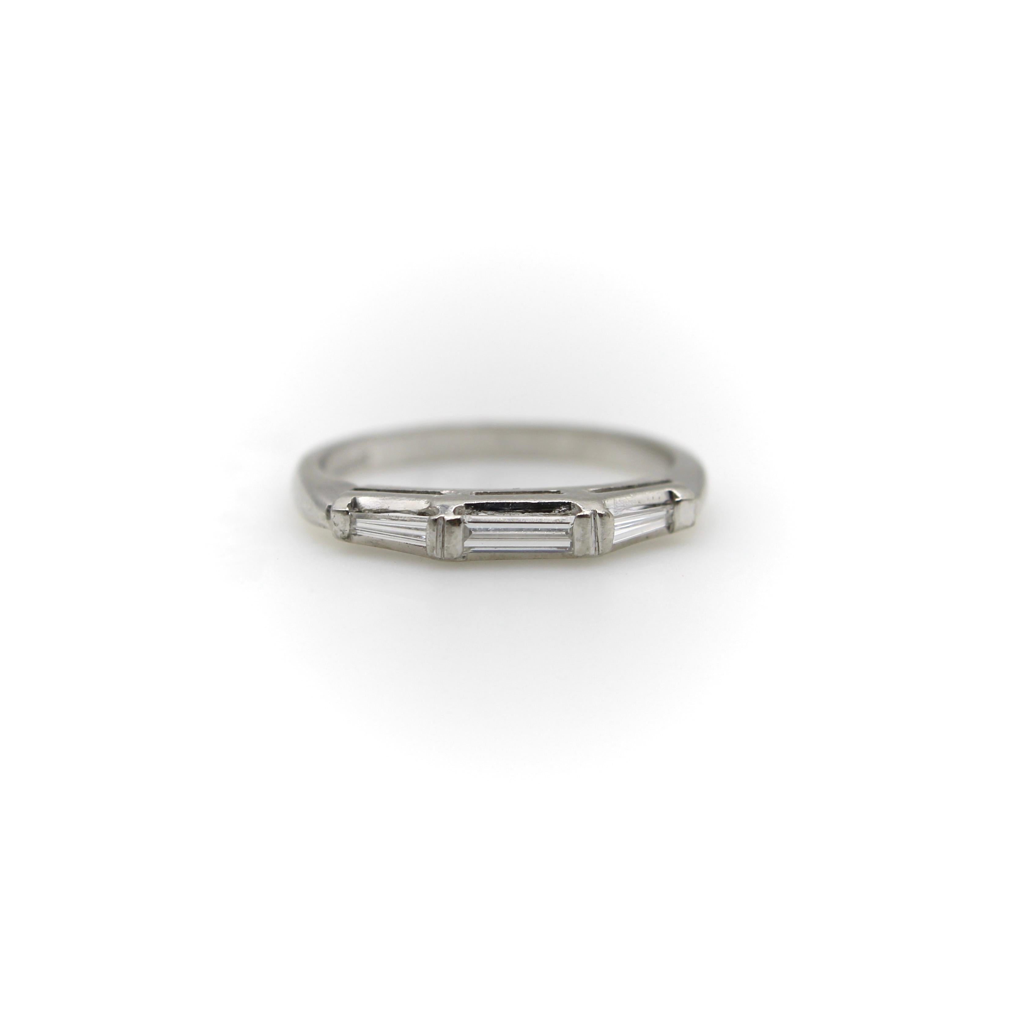 This classic mid-century modern ring would have originally been used as a wedding band. Today it pairs well with platinum bands from the 1950’s, or is a great piece for the current jewelry trend of stacking bands. The platinum band features three