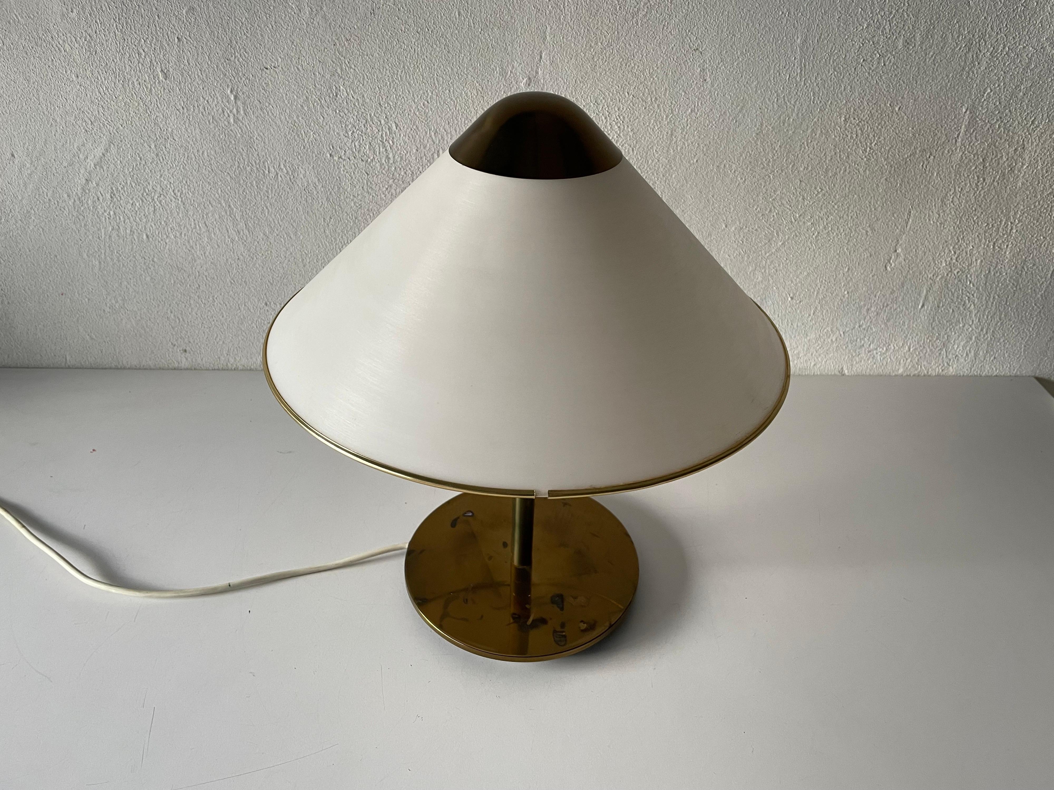 Mid-Century Modern plexiglass and brass luxurious table lamp, 1950s

Lampshade is in very good vintage condition.

This lamp works with 3 x E14 light bulbs. 
Wired and suitable to use with 220V and 110V for all