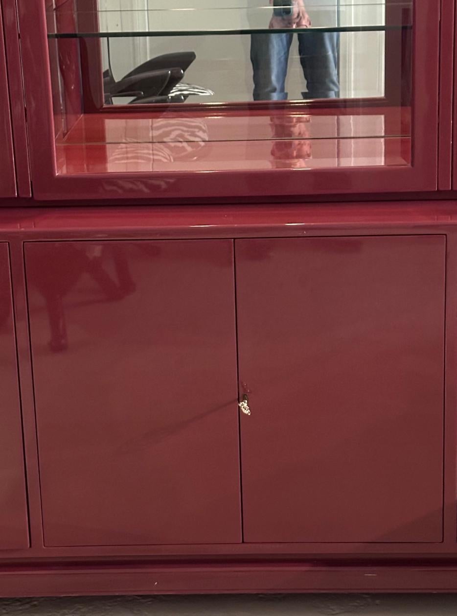 Mid Century Modern Plum Purple Lacquer Showcase Display Cabinet. It includes thick glass shelves with custom made interior drawers on each lower side and compartments lower center.