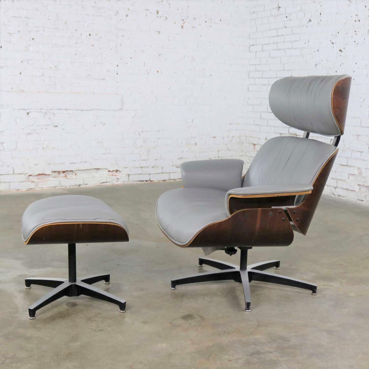 Handsome Plycraft Mid-Century Modern lounge chair and ottoman in the style of Charles and Ray Eames famed chair and ottoman produced by Herman Miller. This pair is in gray vinyl and walnut. They are in fabulous vintage condition but not without some
