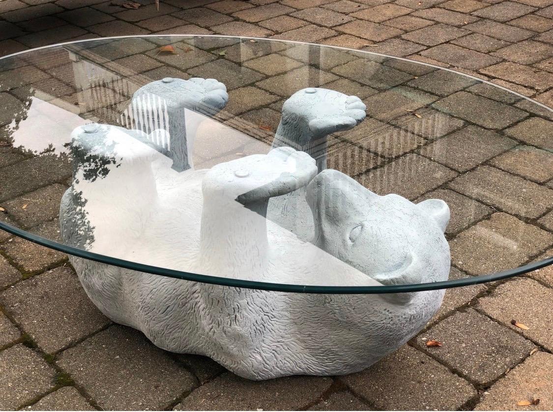 Unusual, figurative midcentury cocktail table with earthenware bear sculpture base and glass top.
Good age appropriate condition. The bear sits upside down with its legs supporting the glass. Great lines and scale. Iconic whimsical table for any