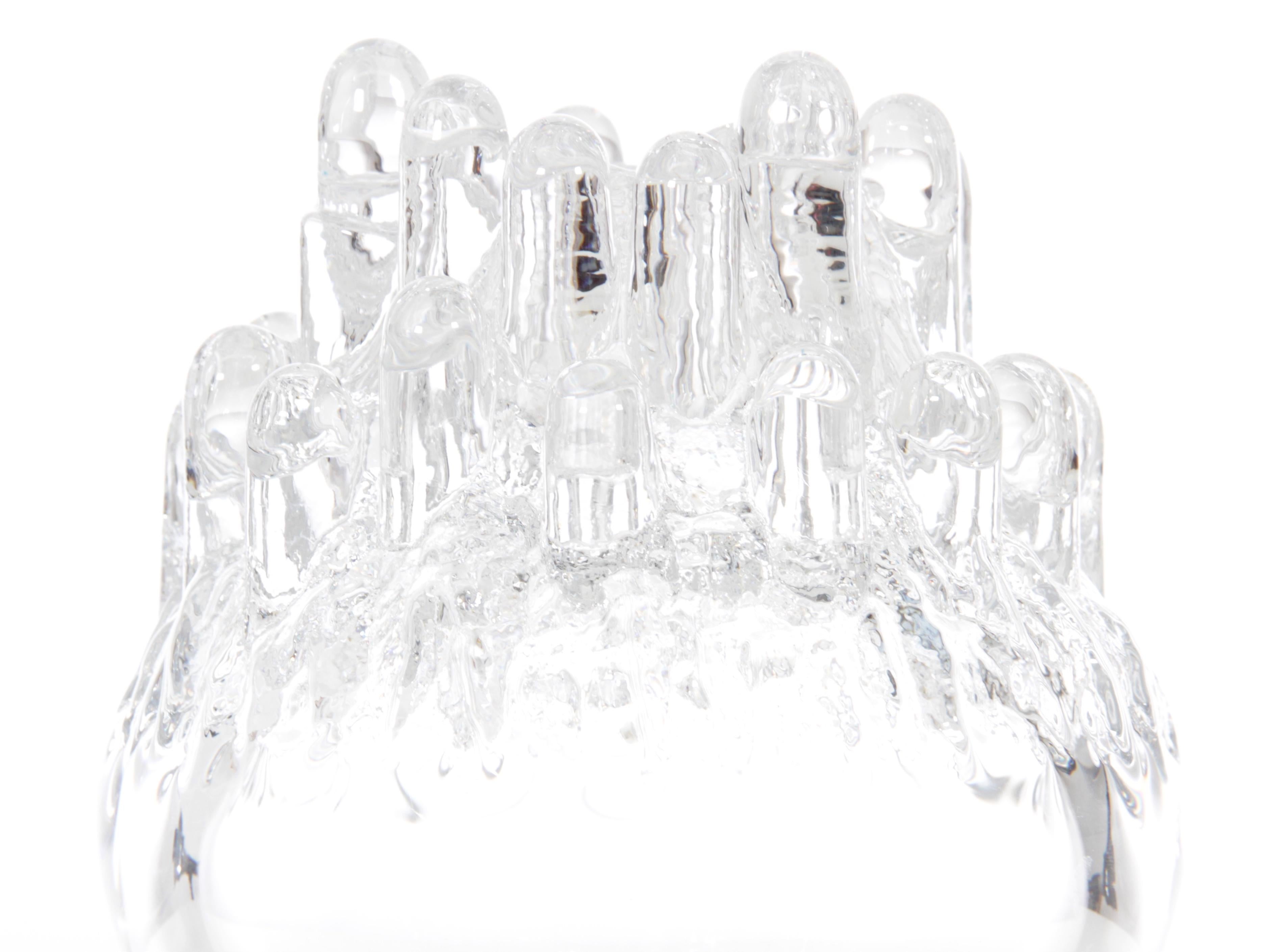 Polar candleholders are a Swedish classic.
When Goran Warff created the Polar collection in the late sixties at Kosta Boda, he gave his candlesticks a form of ice block playing on the contrast of ice and fire. The forms of stalactites allow the