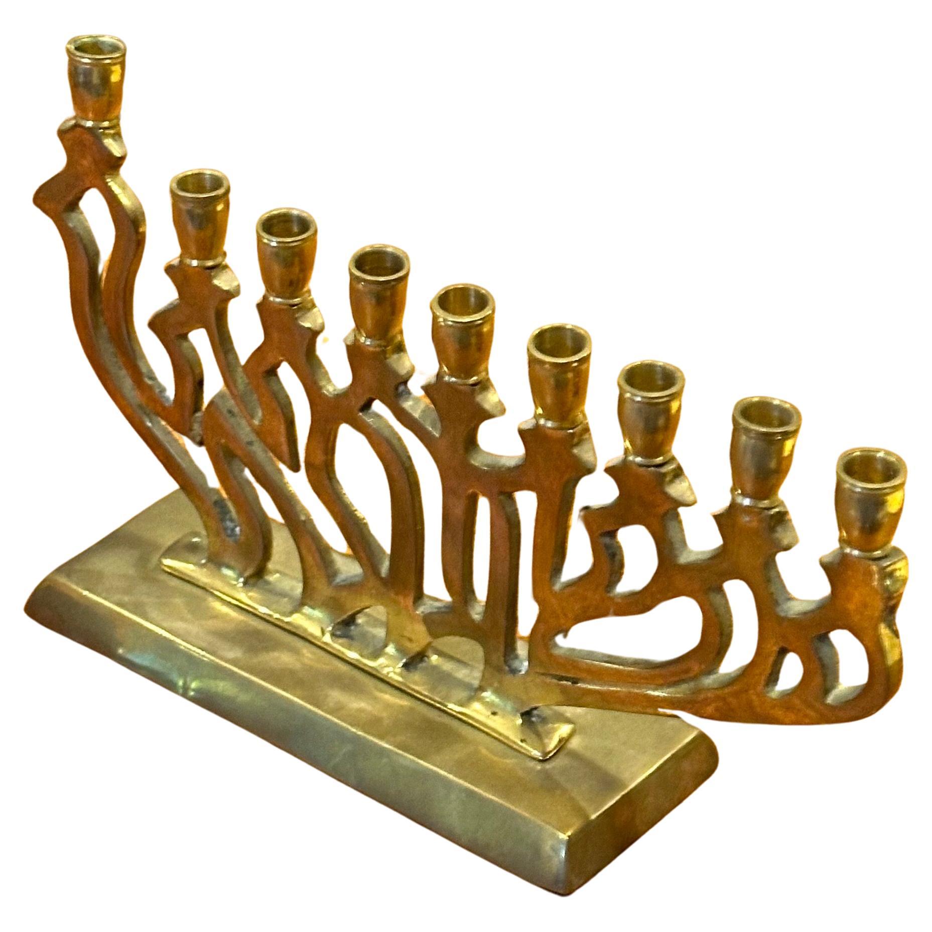 Mid-century modern polished brass menorah, circa 1970s. The piece is in very good vintage condition and measures 7.75