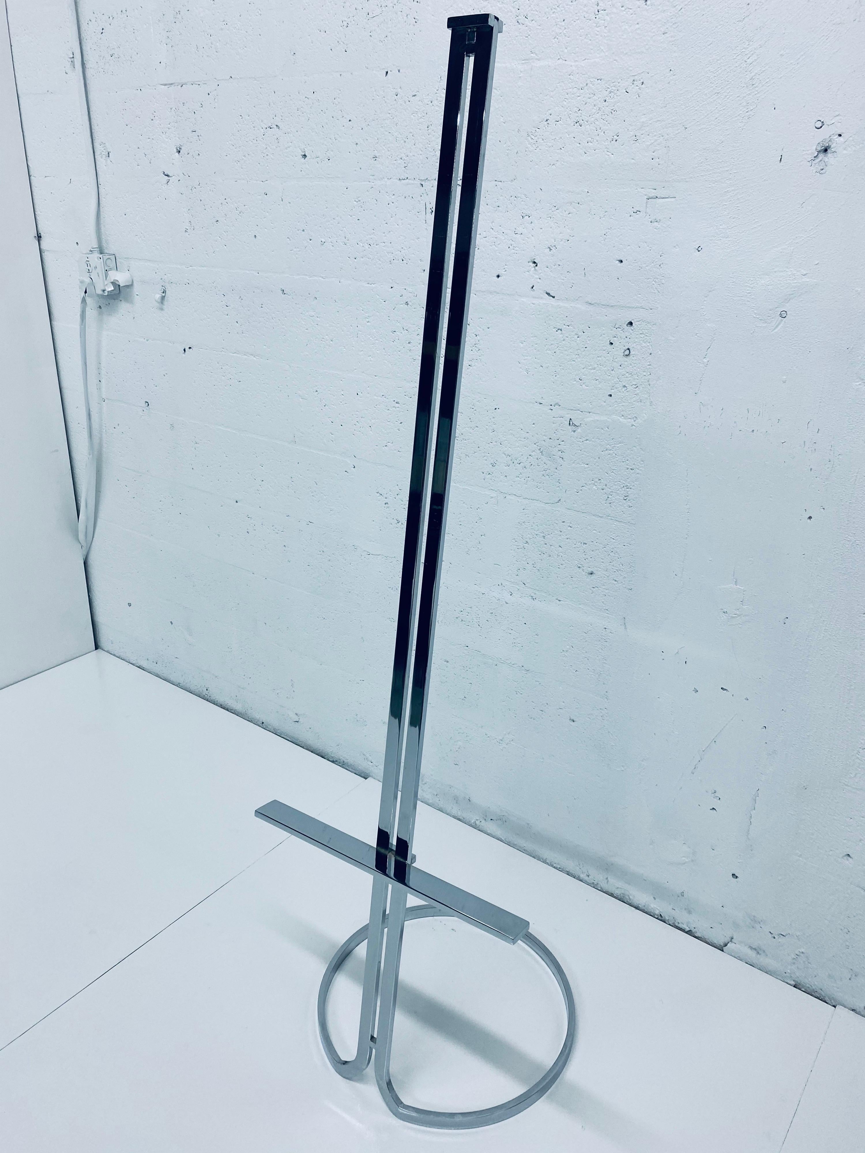 Polished chrome art easel from Italy, 1970s. Easel has double stem design with adjustable ledge and a stylized circular base.