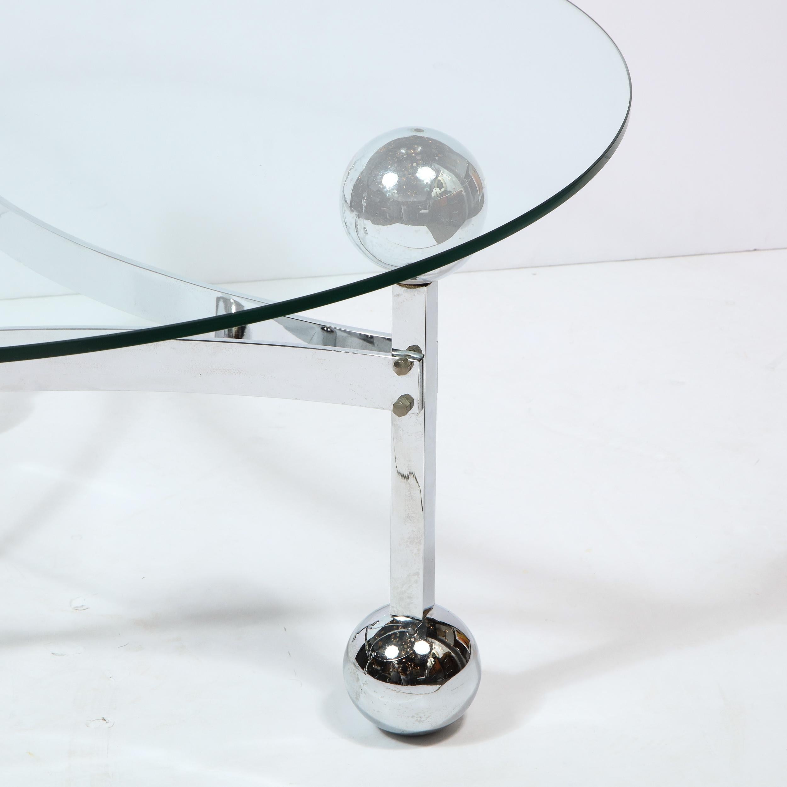 This stunning Mid-Century Modern cocktail table was realized in the United States circa 1970. It features three rectangular legs capped on each end with a sphere, connected by concave demilune form supports- all in lustrous chrome. Full of verve and