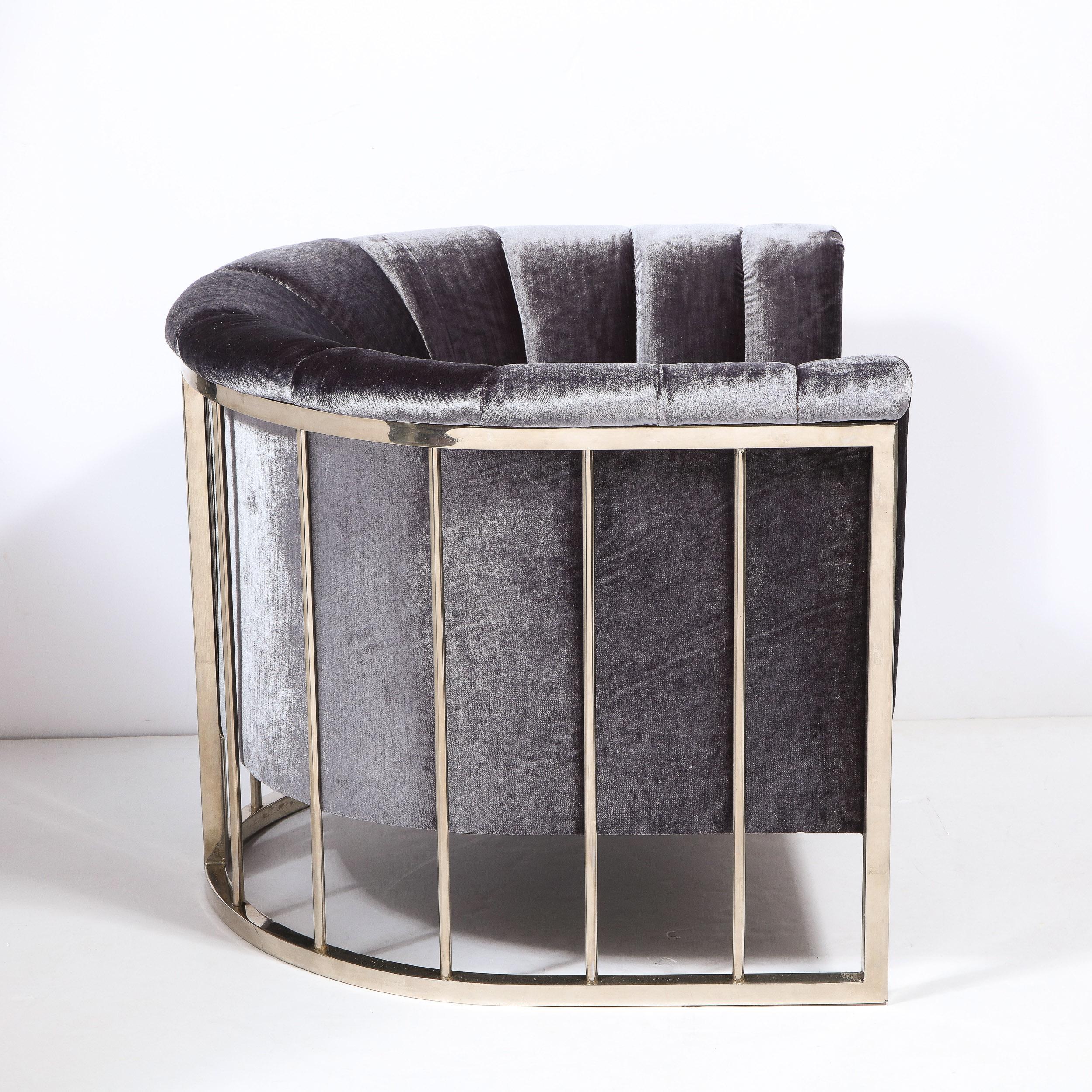 This stunning and sculptural lounge/arm chair designed in the manner of the esteemed American designer Milo Baughman in the United States circa 1970. It features a rail back design consisting of a demilune frame consisting of bent and welded