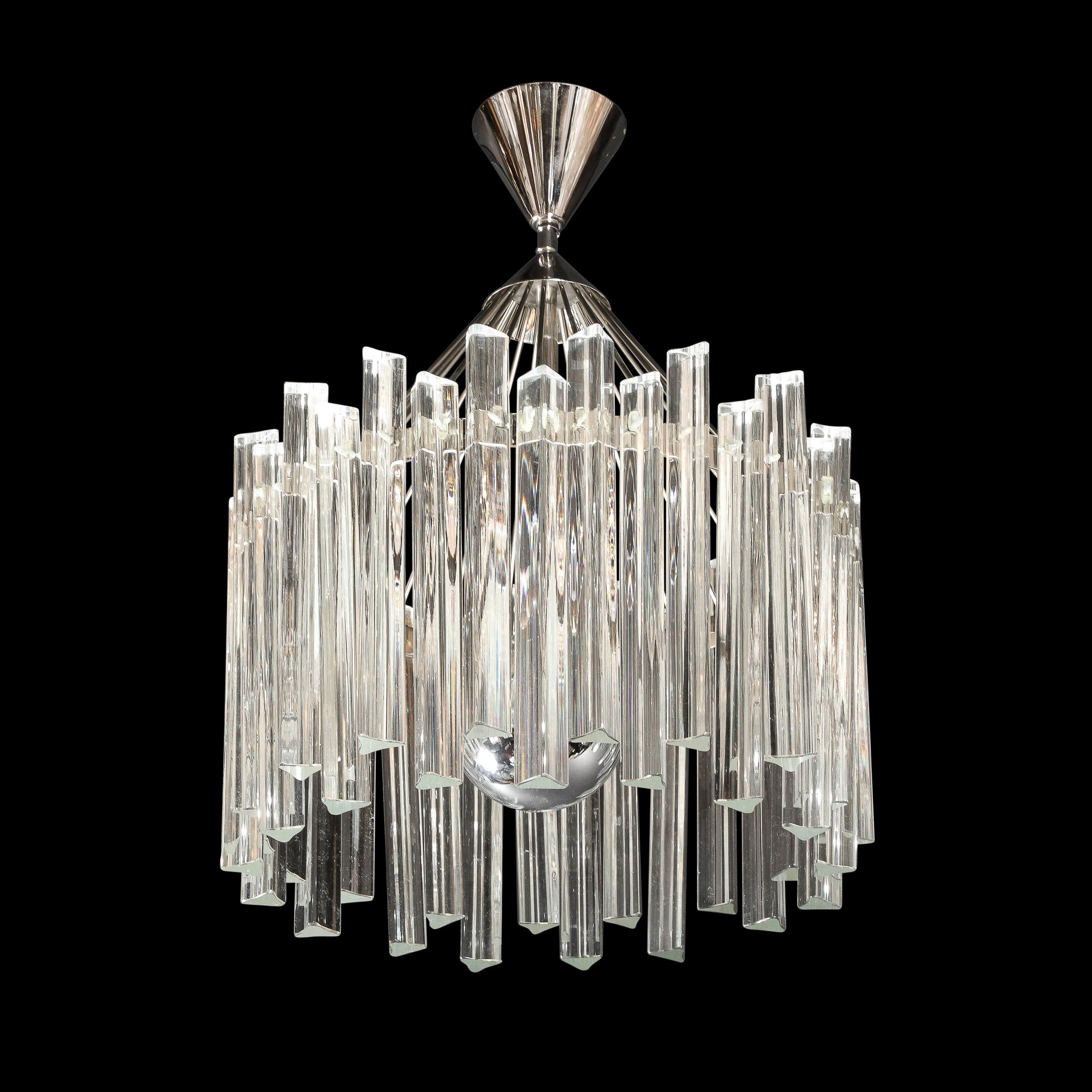 This stunning Mid Century Modern chandelier was realized in Murano, Italy circa 1970. It features a circular open form frame in lustrous polished chrome. with a wealth of translucent hand blown staggered Murano triedre crystals suspended around the
