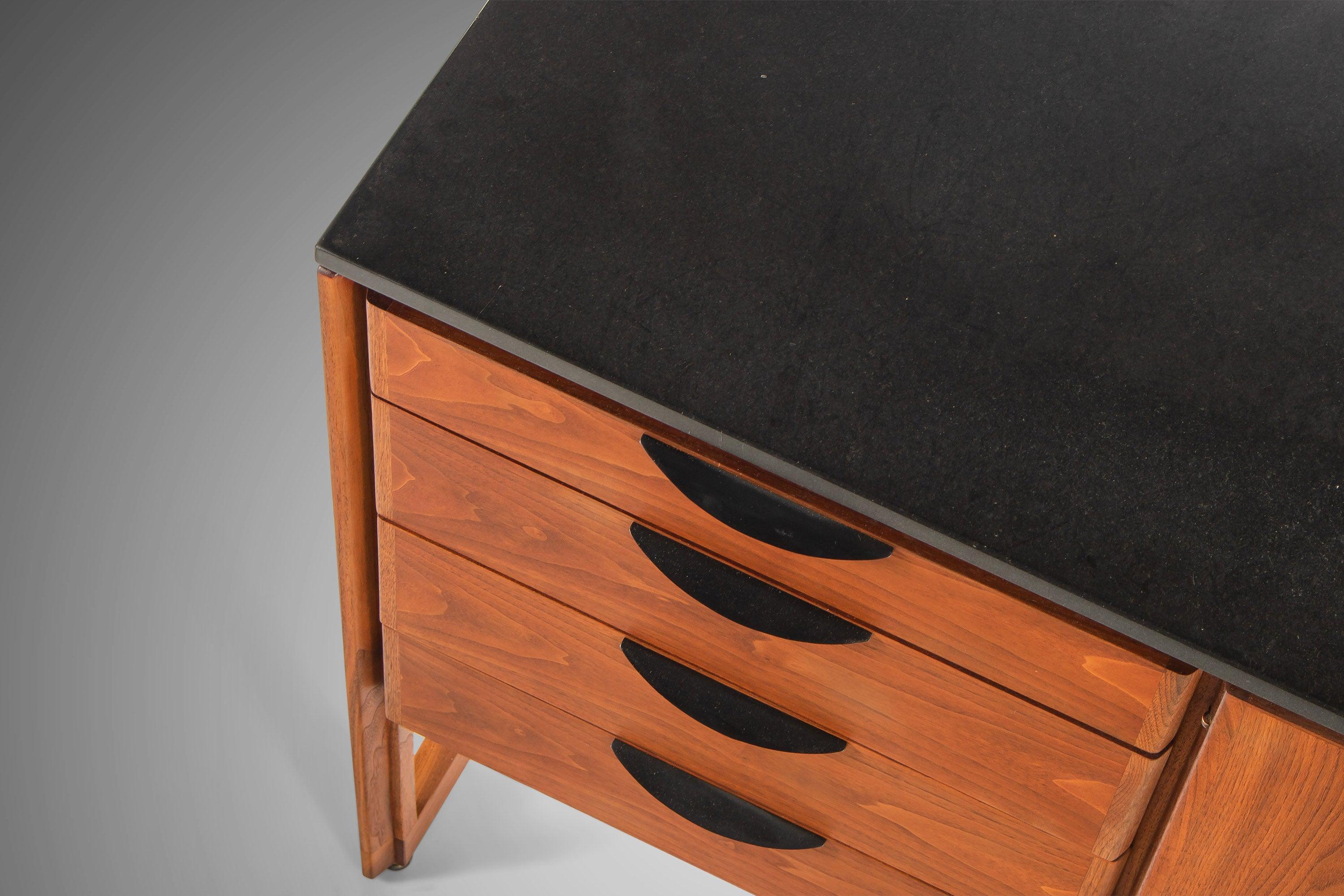 A rare case piece by American furniture design icon, Jens Risom, that is substantial, stately and utterly sublime. Constructed from walnut and set on a sled base. The cabinet has four left facing drawers with distinctive concave pulls. There are two