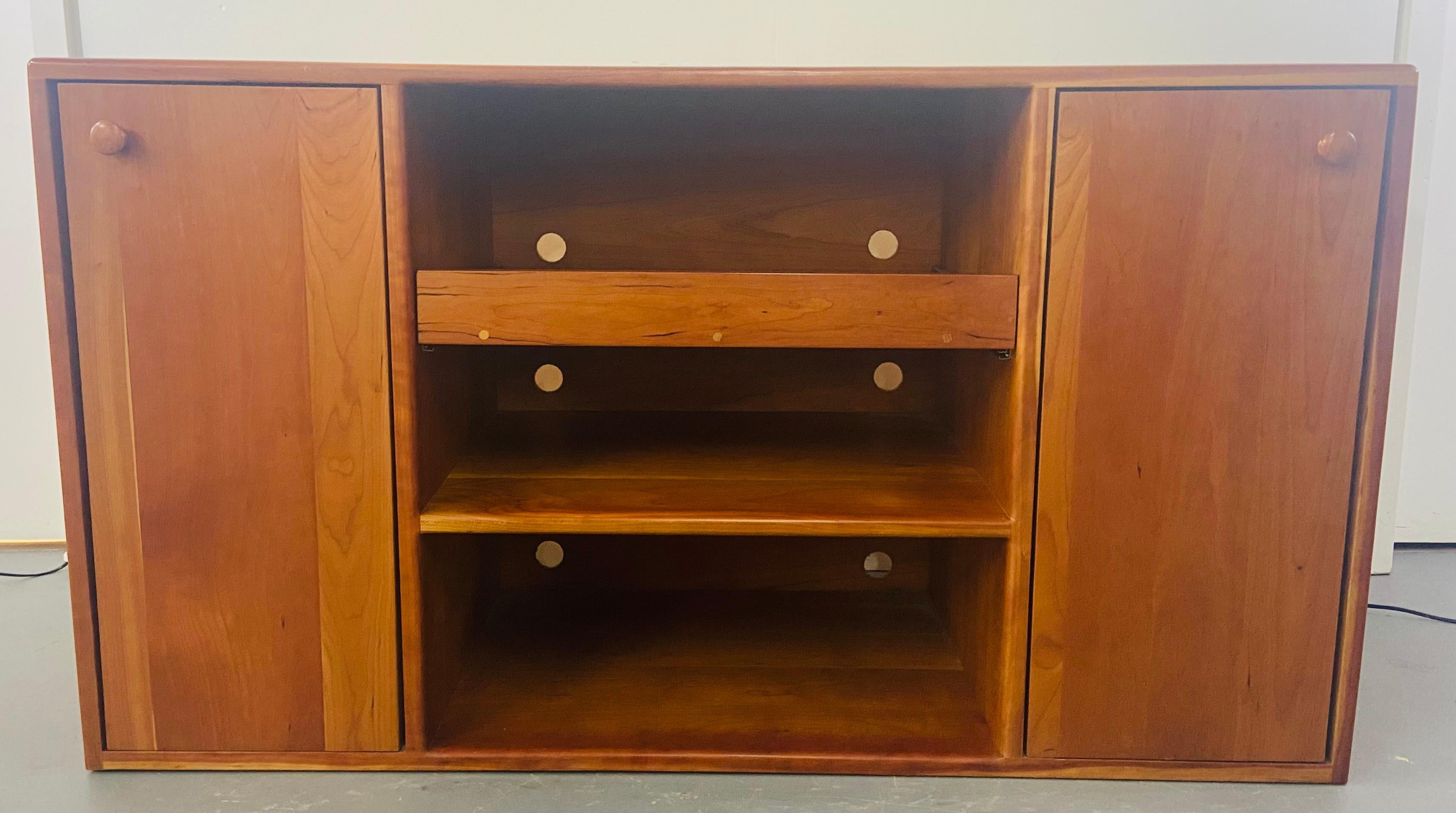 A rare Mid-Century Modern style custom made stereo cabinet by the quality hardwood furniture maker Pompanoosuc Mills in cherrywood. The cabinet provides multiple shelves units and 4our drawers for storage of music records and additional items.