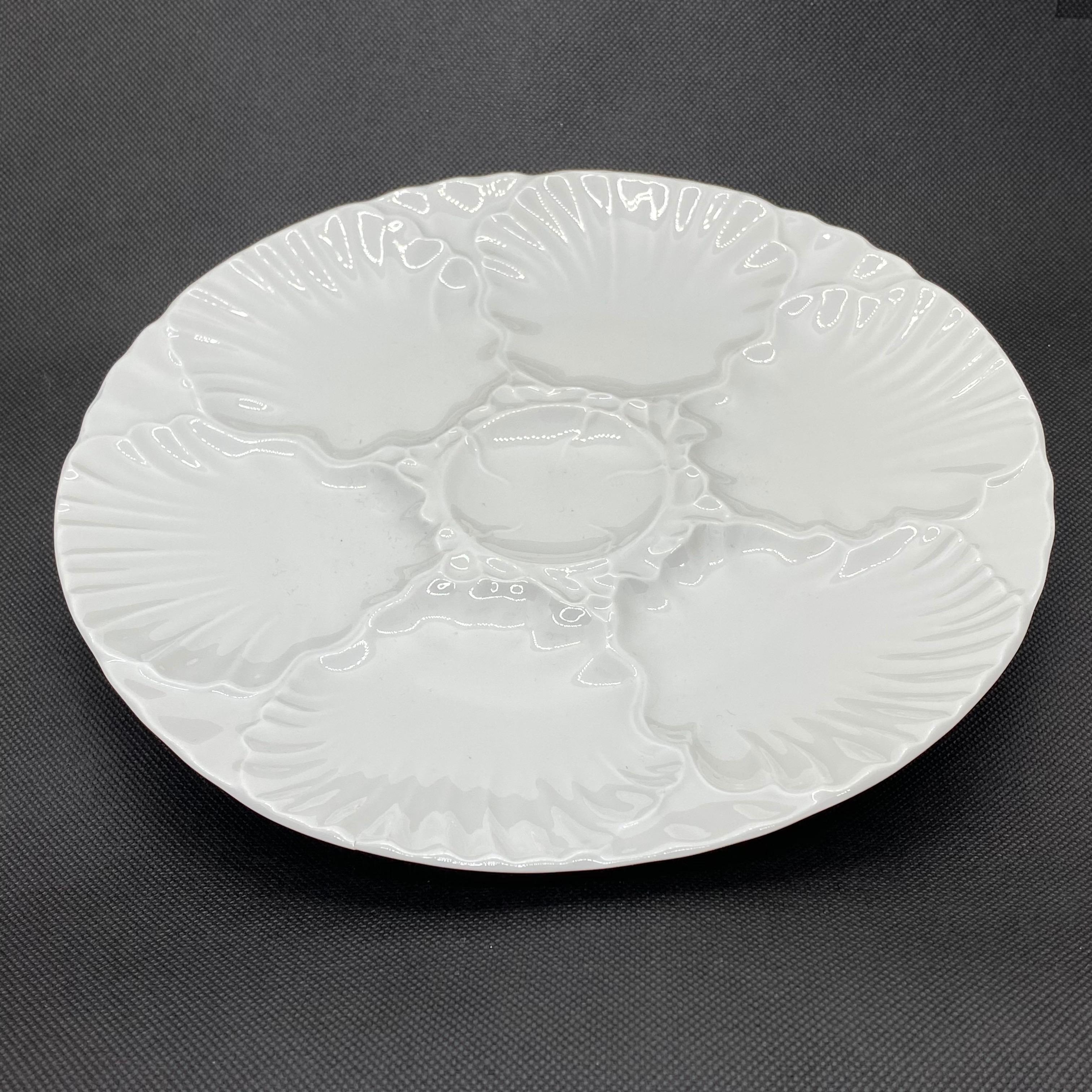 This beautiful oyster plate features 6 wells for oysters and one for the sauce or lemon. It is marked at the back with manufactory sign. Nice addition to your table or just to display. It has no chips, cracks or repairs.