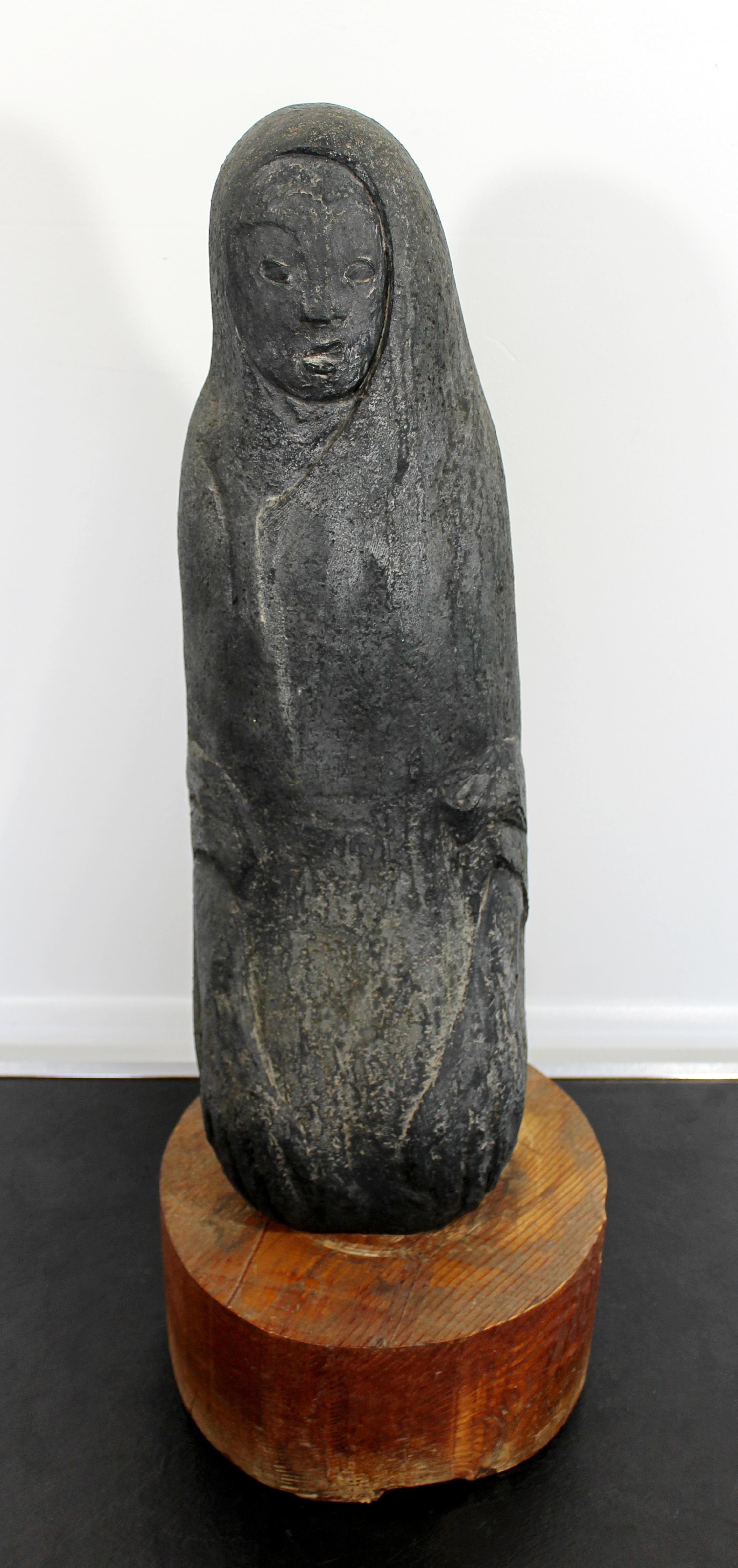 For your consideration is a stunning, porous stone sculpture of an abstracted figure, on a wooden base. In excellent condition. The dimensions are 9.5