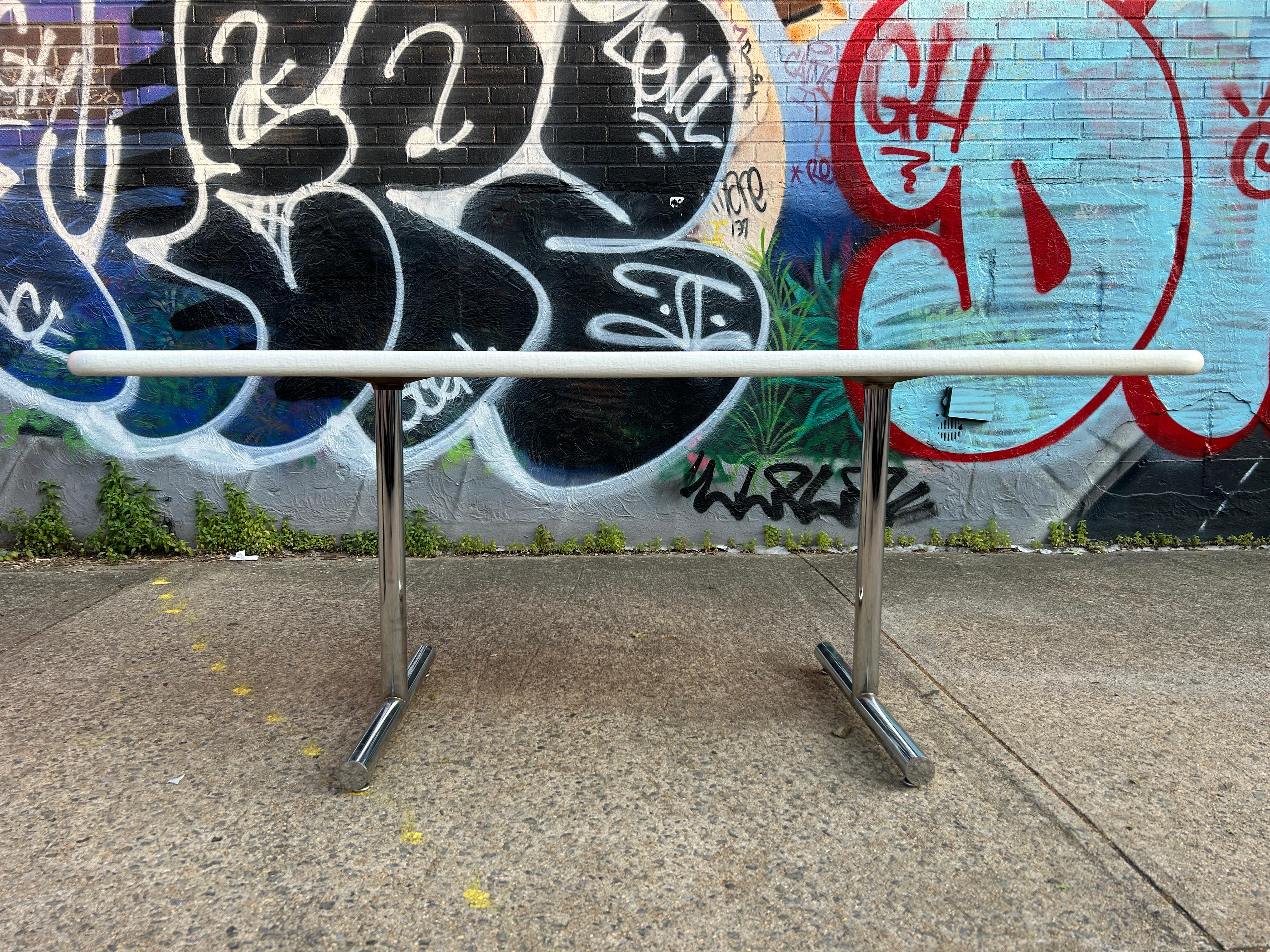 Midcentury post Modern Design rectangular rounded corners white fiberglass dining table. white fiberglass over wood table top on round chrome double pedestal base with adjustable feet. Table has fiberglass texture on top surface and is very clean